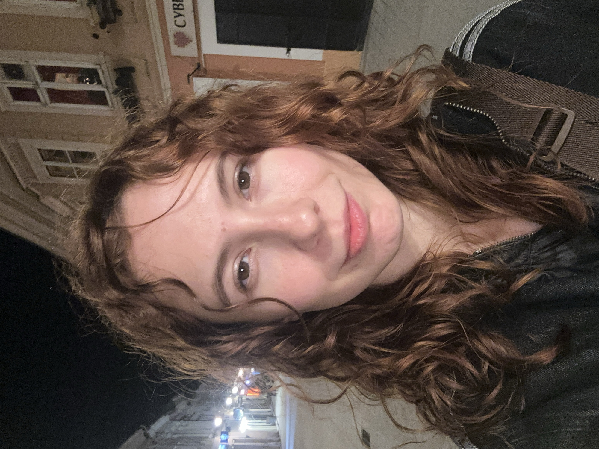 Woman takes nighttime selfies at Serbian National Theatre, Novi Sad