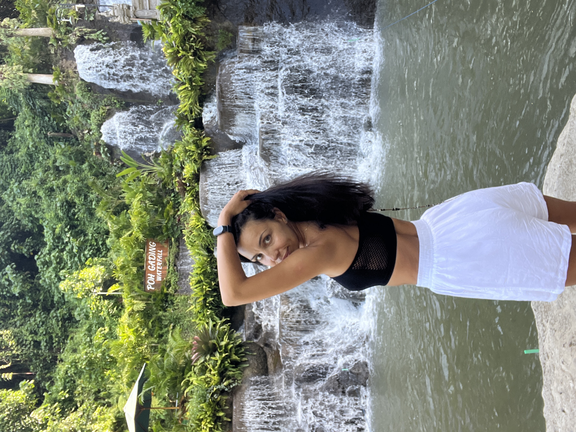 Tourist visits Poh Gading Waterfall in Sukawati, Indonesia