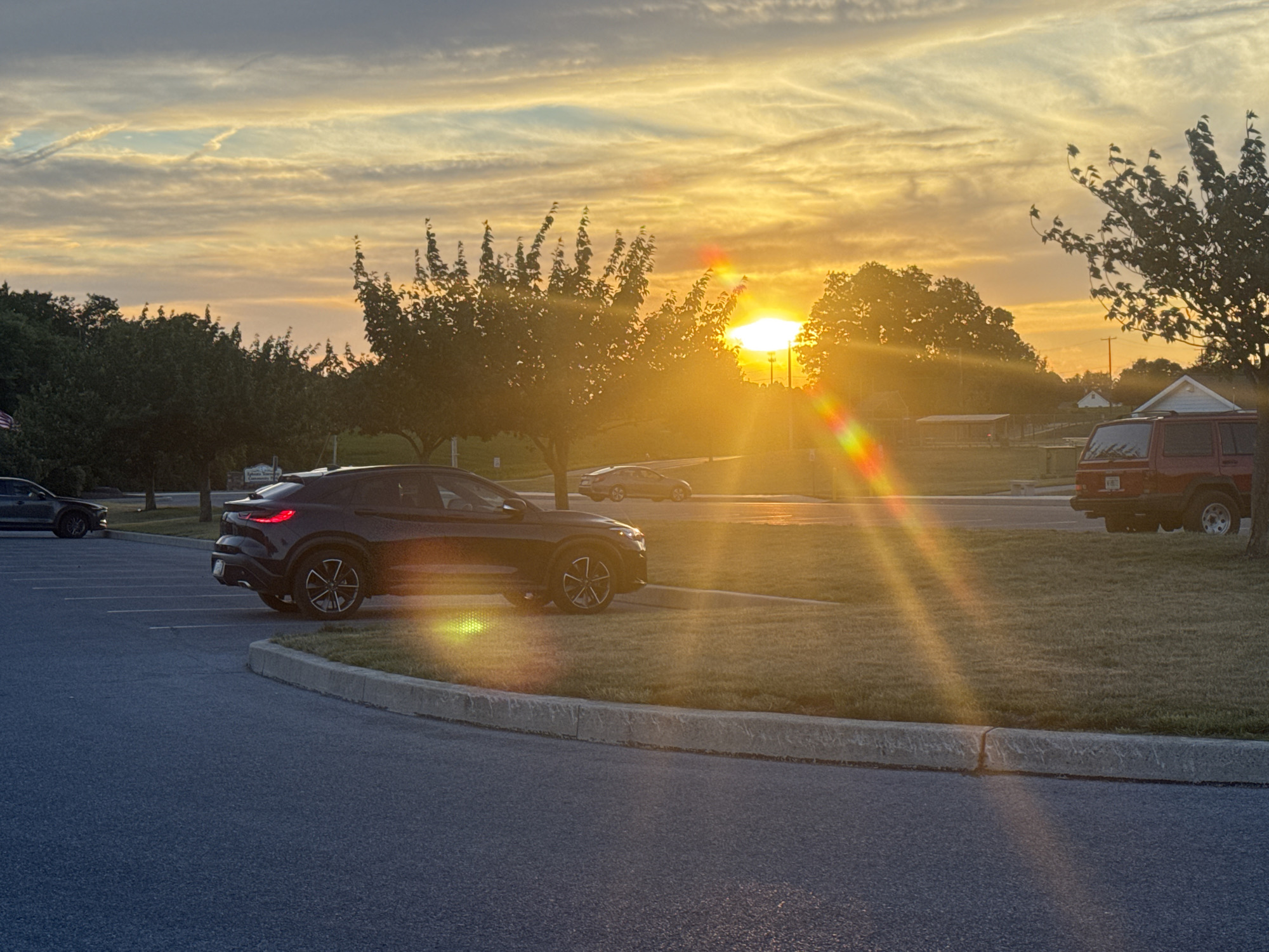 Parking lot at sunset, asphalt and grass at dusk