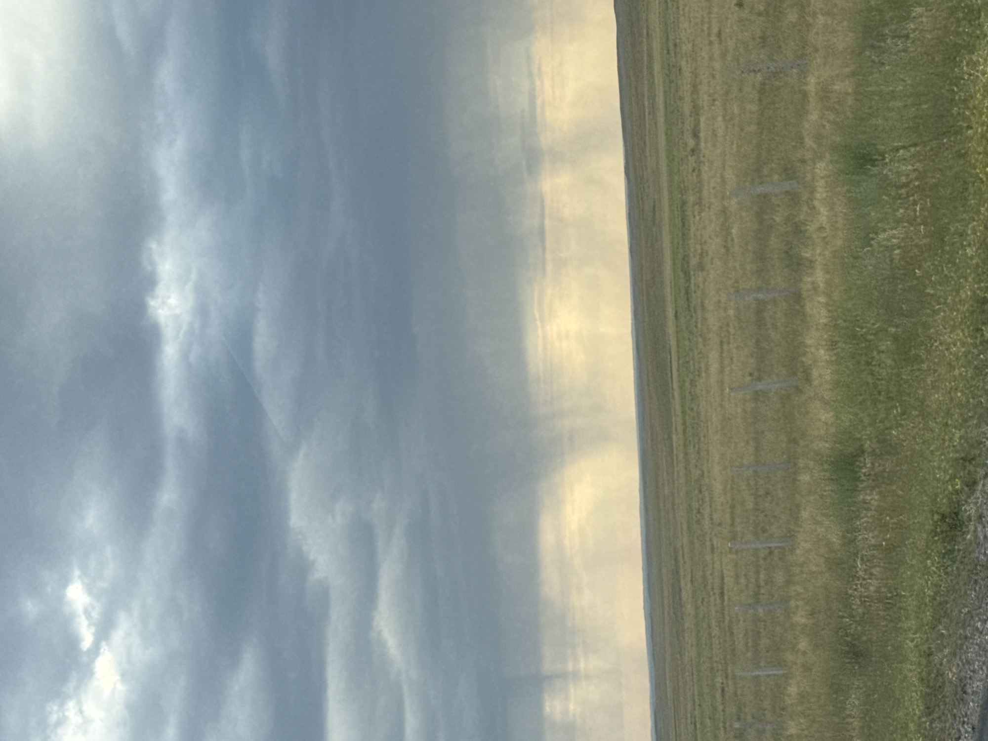Rain shafts cut through an overcast Kazakhstan steppe sky