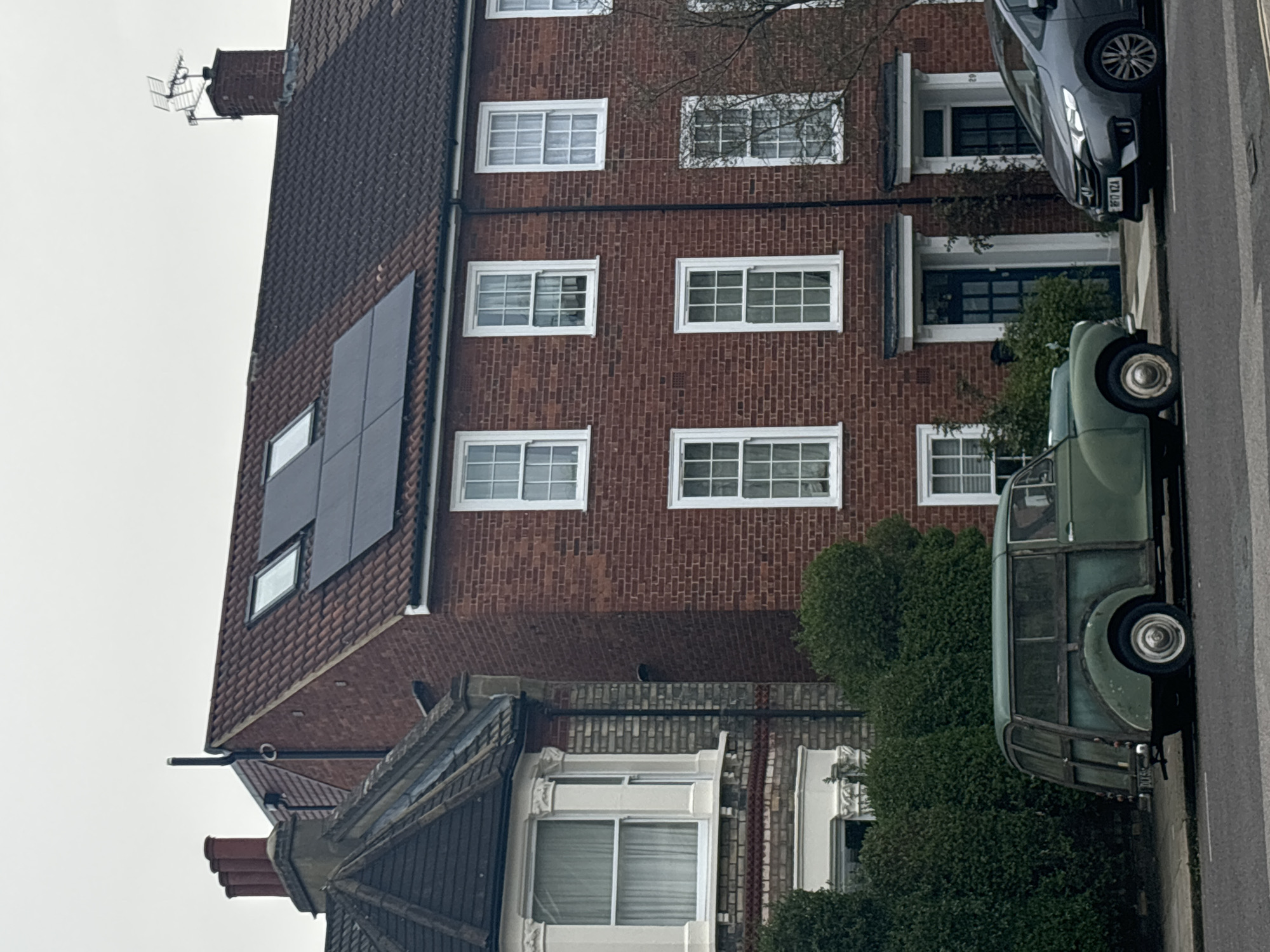 London residential street with solar-paneled brick buildings observed