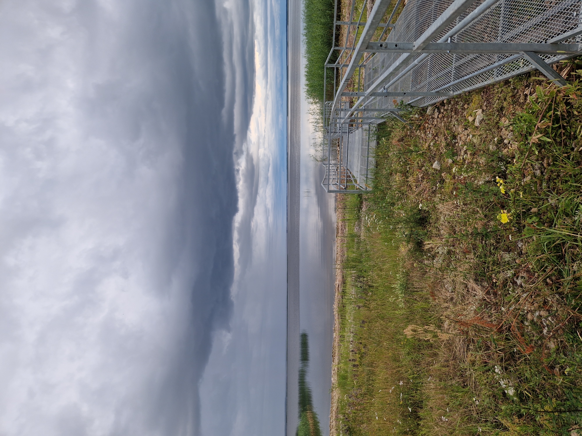 Overcast evening at a calm Latvian lakeside boardwalk