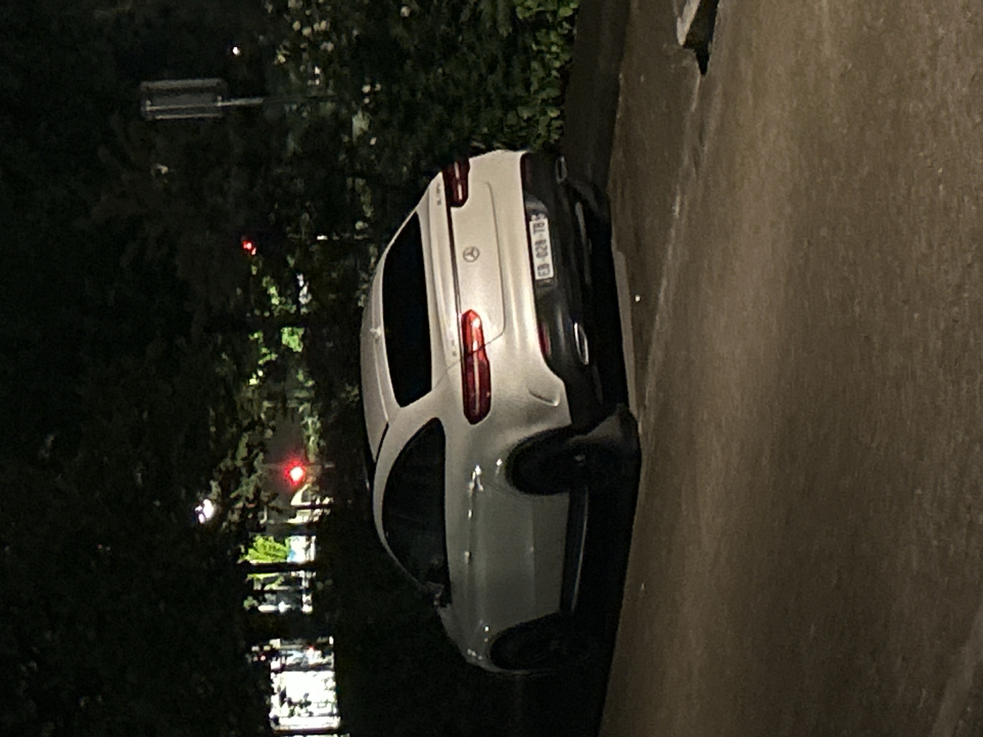 White Mercedes parked on Strasbourg street at night