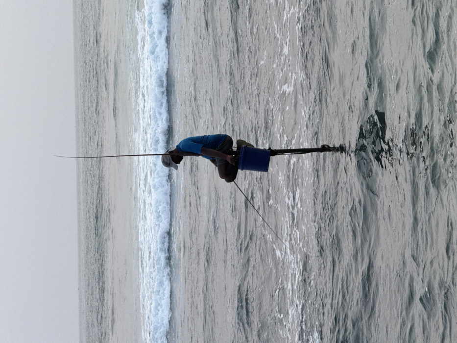 Daily life unfolds along Talpe's coastline with fishermen and beachgoers