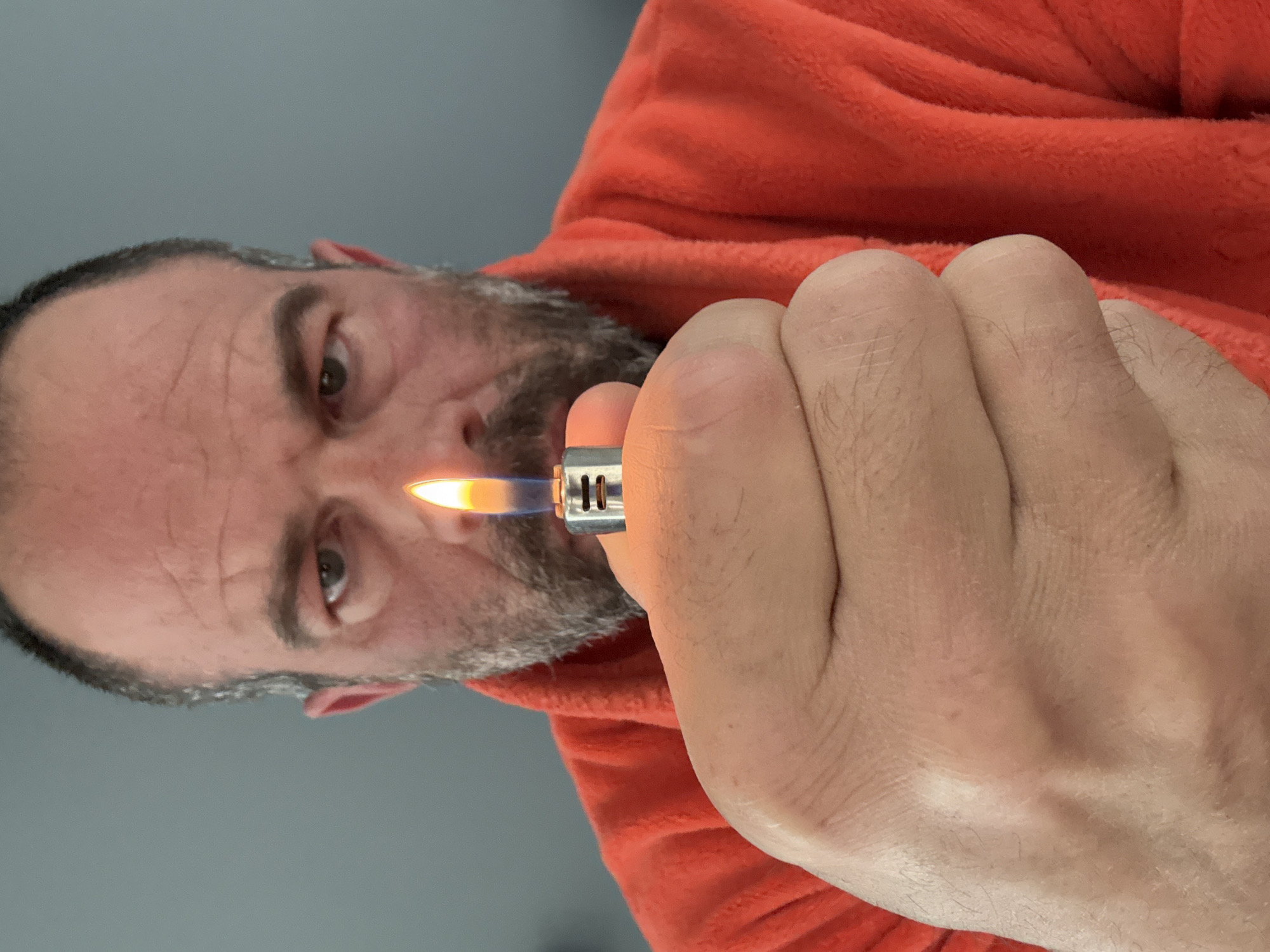 Man operates lighter indoors in Marche-en-Famenne, Belgium