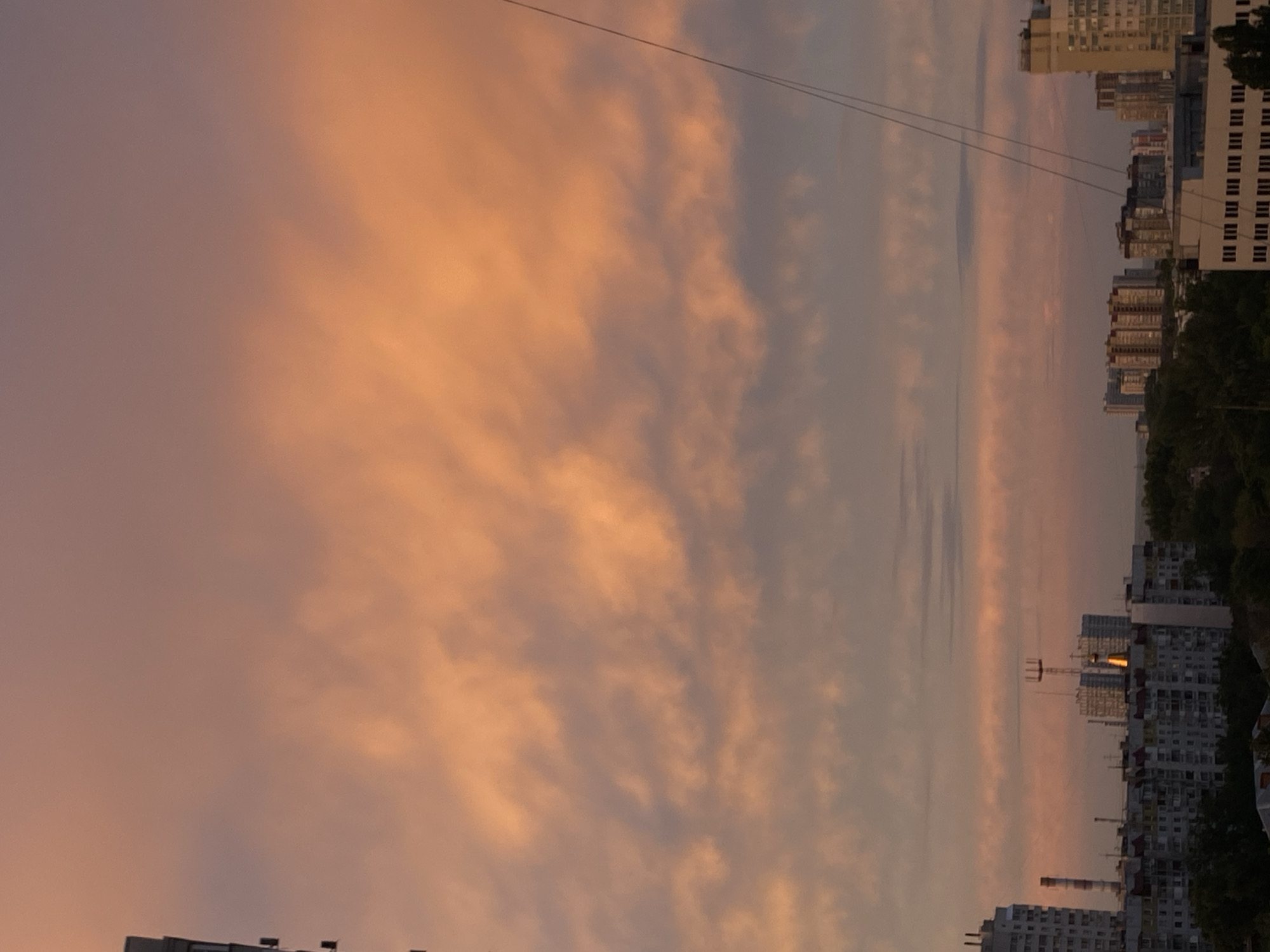 Sunset over high-rise apartments, dramatic sky on full display