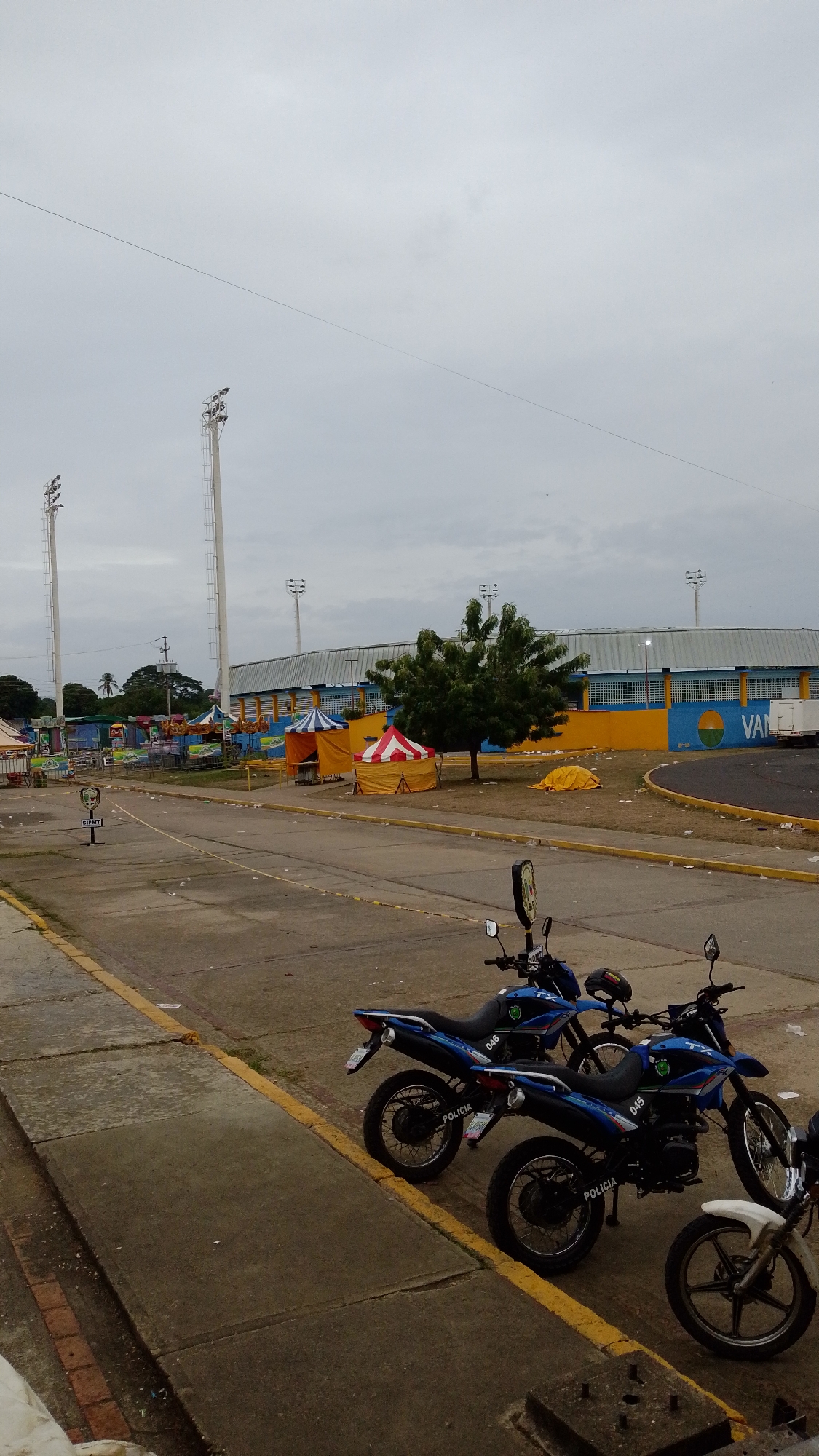 Police motorcycles stationed amid debris in Tinaquillo commercial area