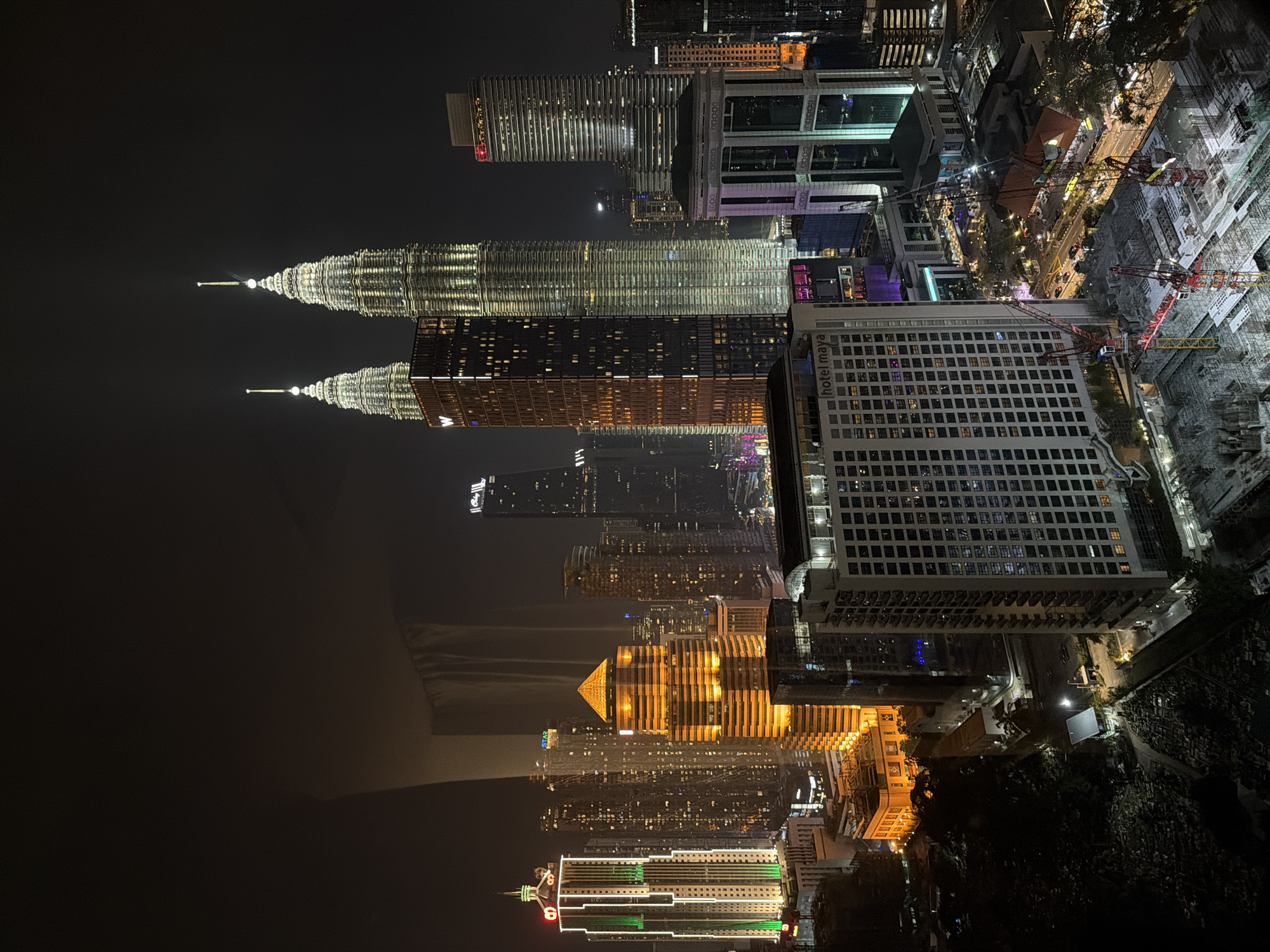 Petronas Twin Towers lit up over Kuala Lumpur at night