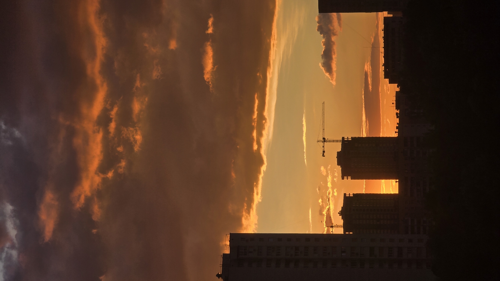 Kyiv skyline silhouetted against a sunset sky