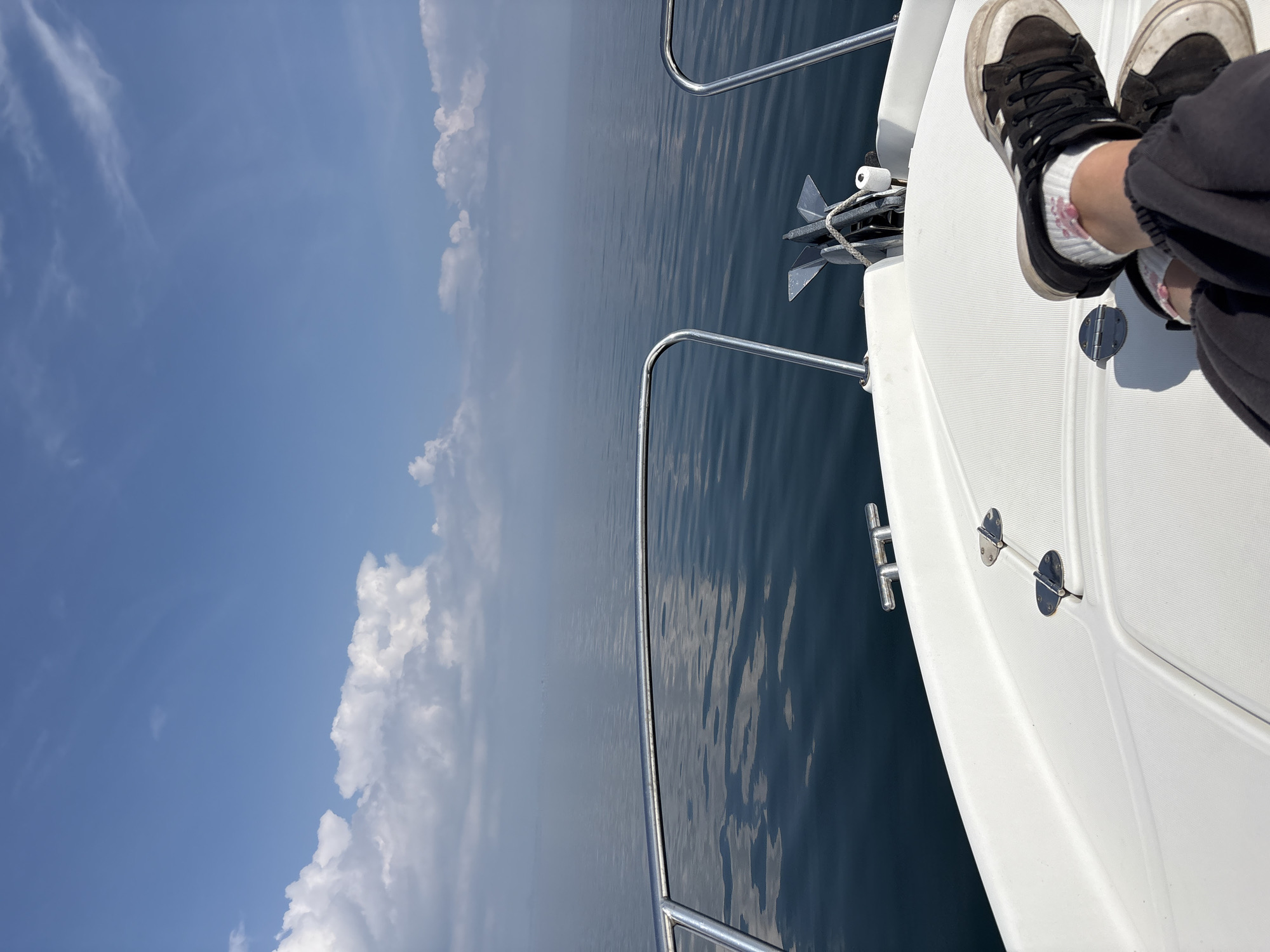 Person sits on boat deck in calm Black Sea waters
