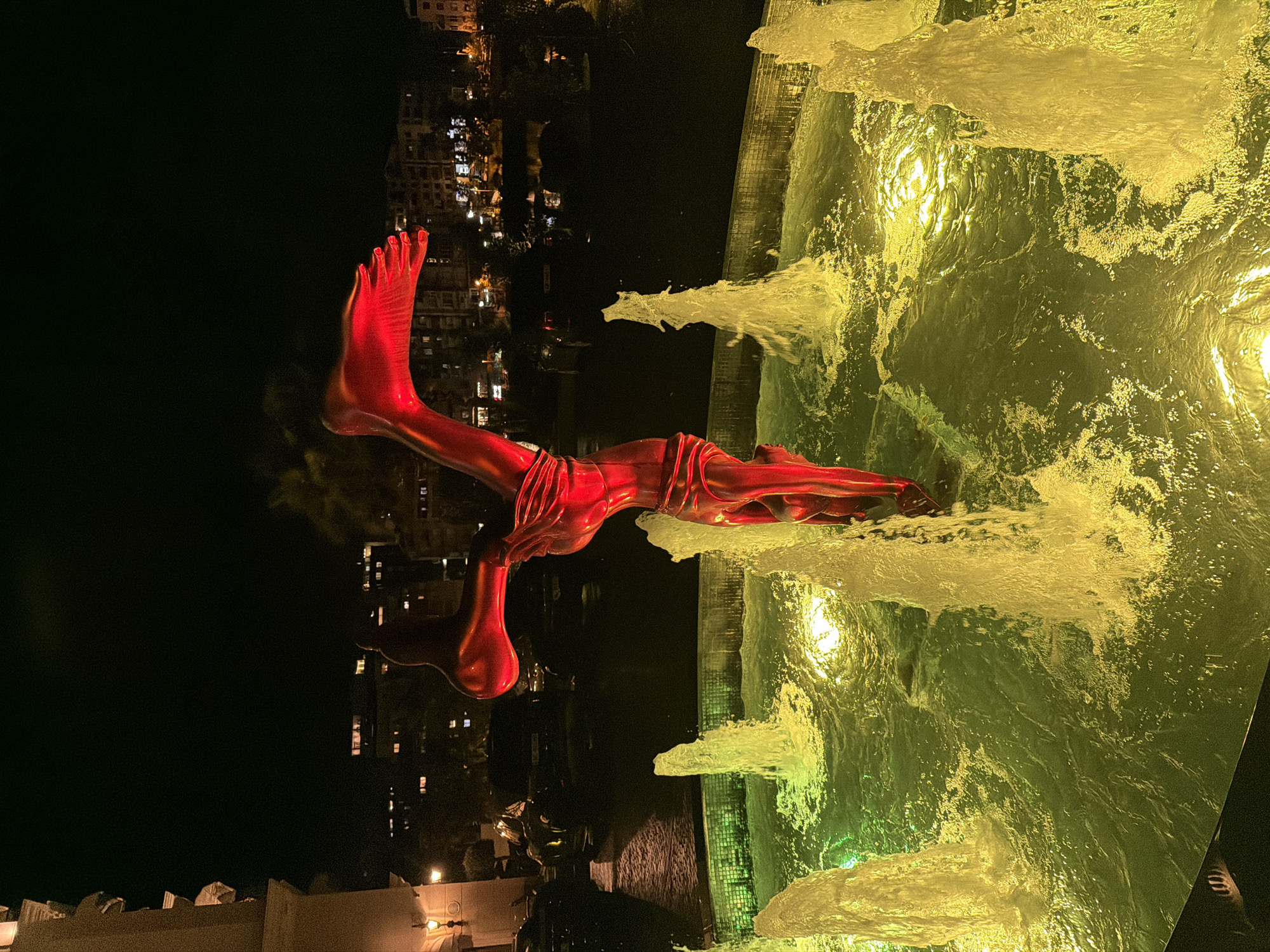 Albanian nighttime scenes feature fountain sculpture and resort television display