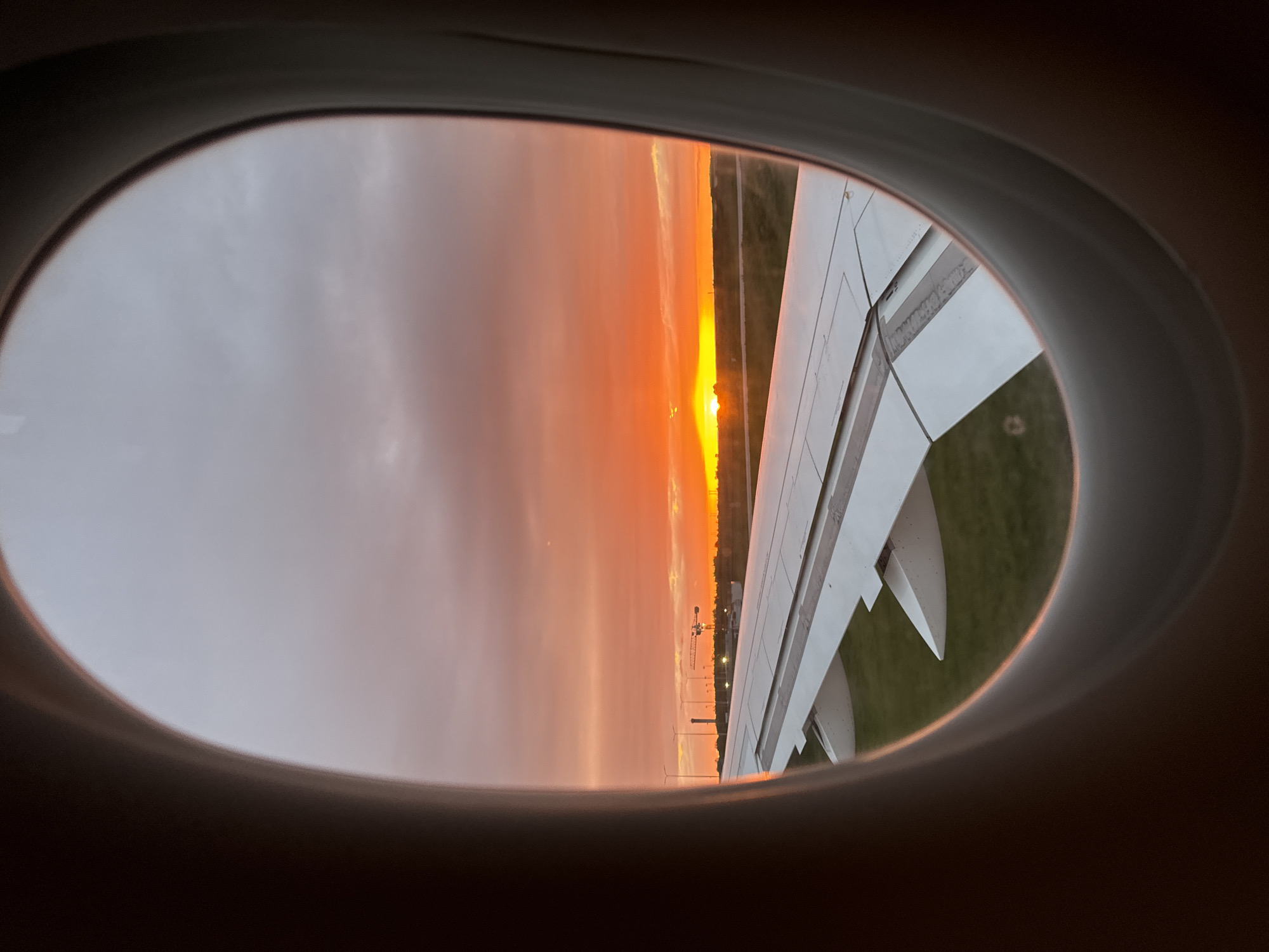 Passenger captures sunset view from airplane window over France