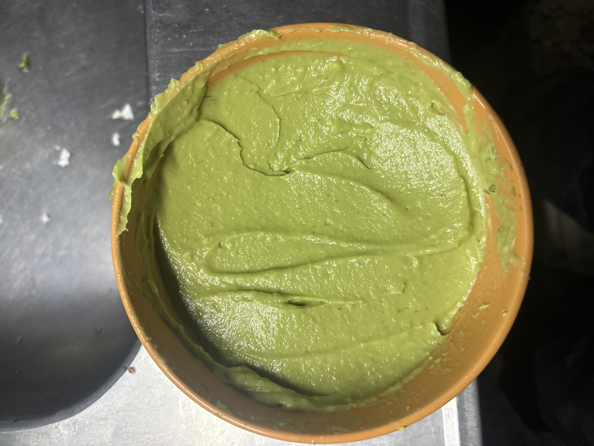 Late-night guacamole preparation captured in Buenos Aires kitchen