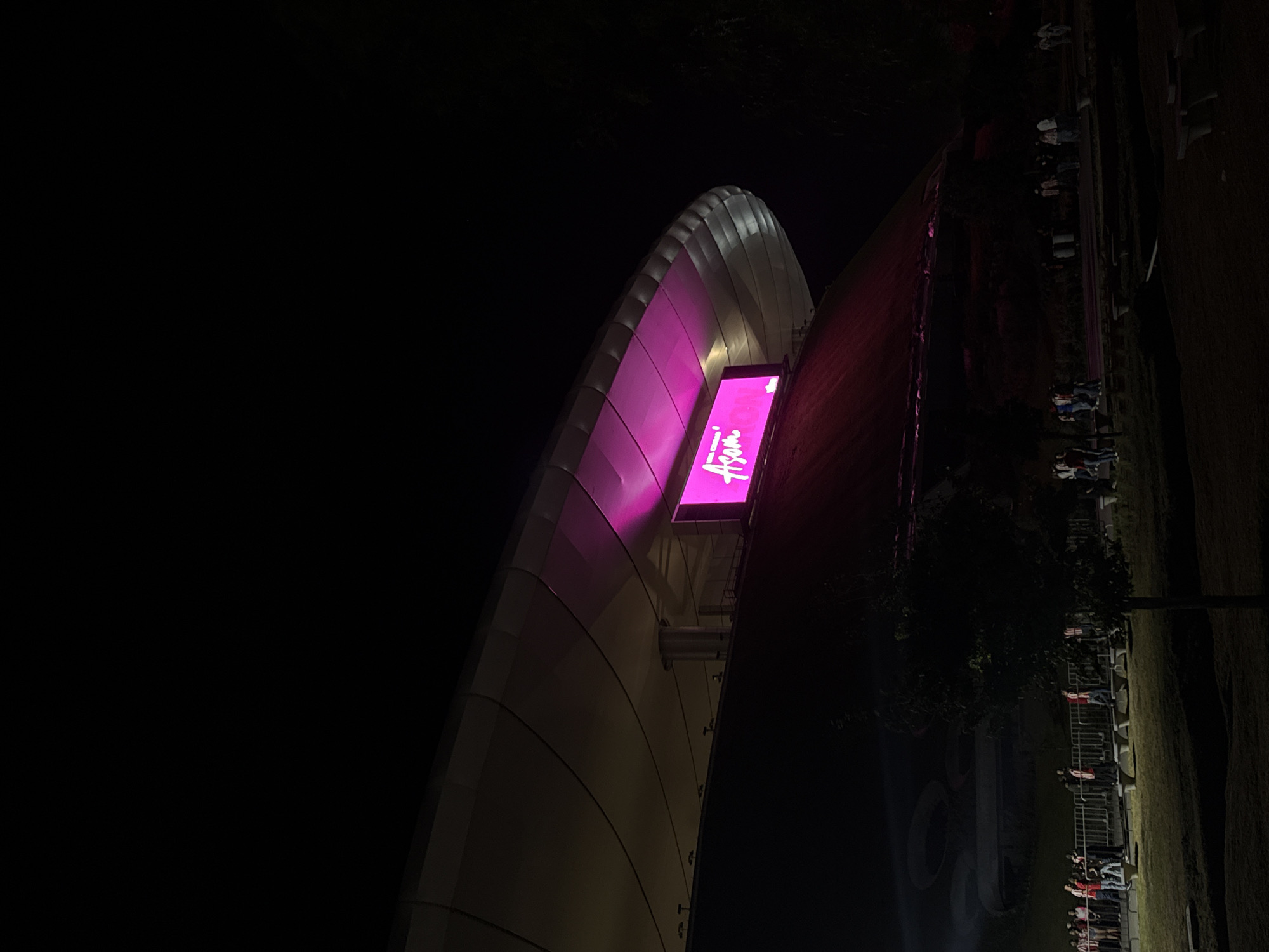 Akron Stadium lit pink during nighttime event in Zapopan