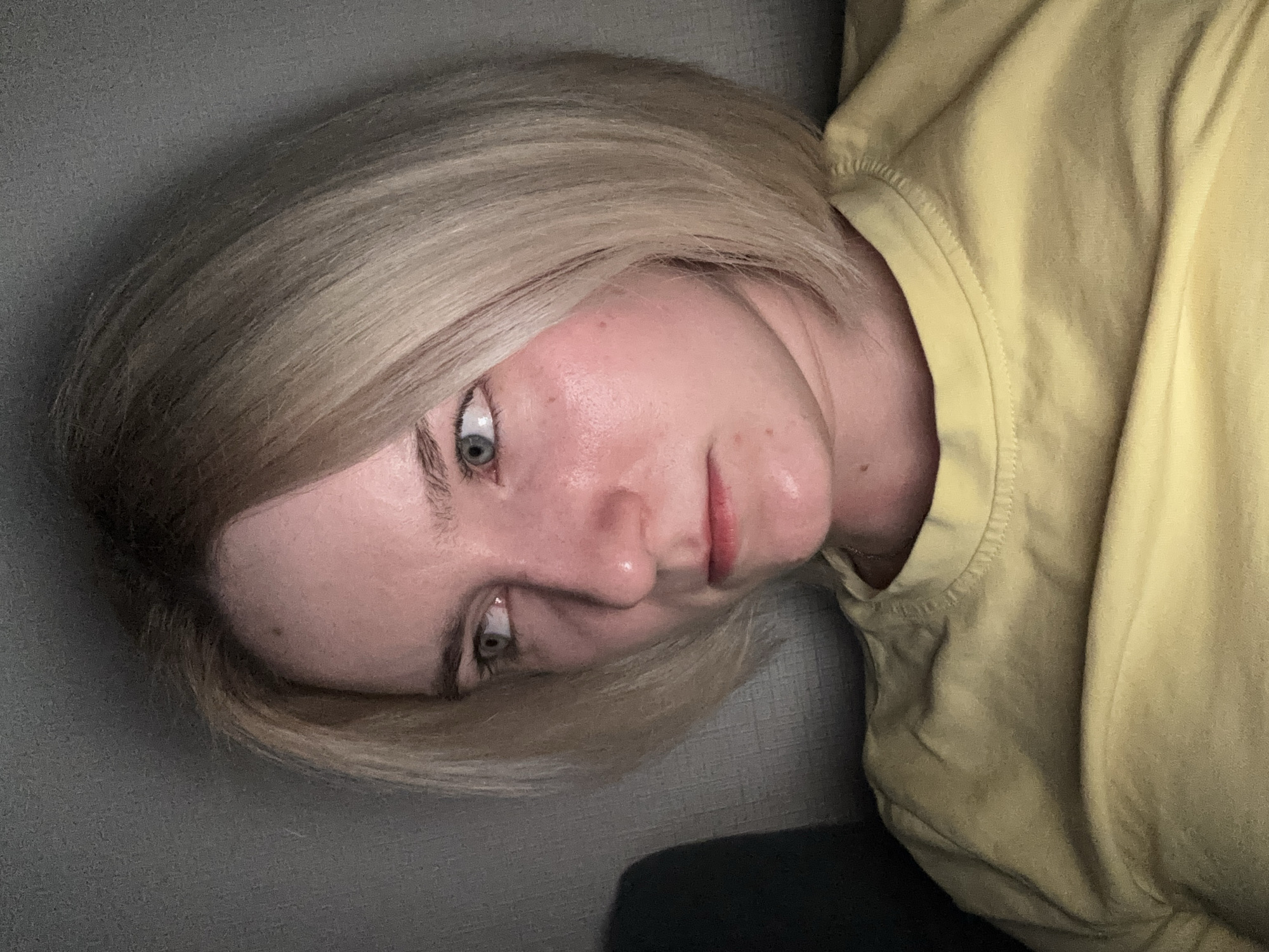 Woman in yellow shirt resting on couch in Vsevolozhsk