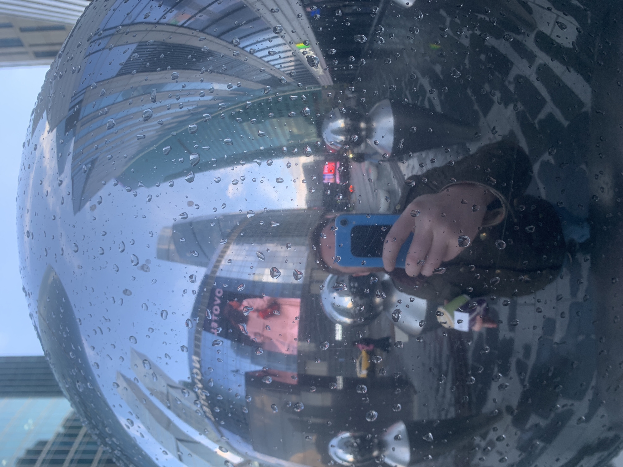 Rain-covered art sphere reflects urban skyline in Khimki
