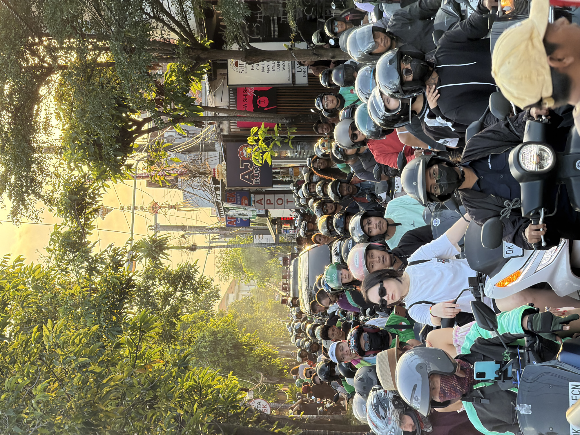 Dense motorcycle traffic clogs a North Kuta street