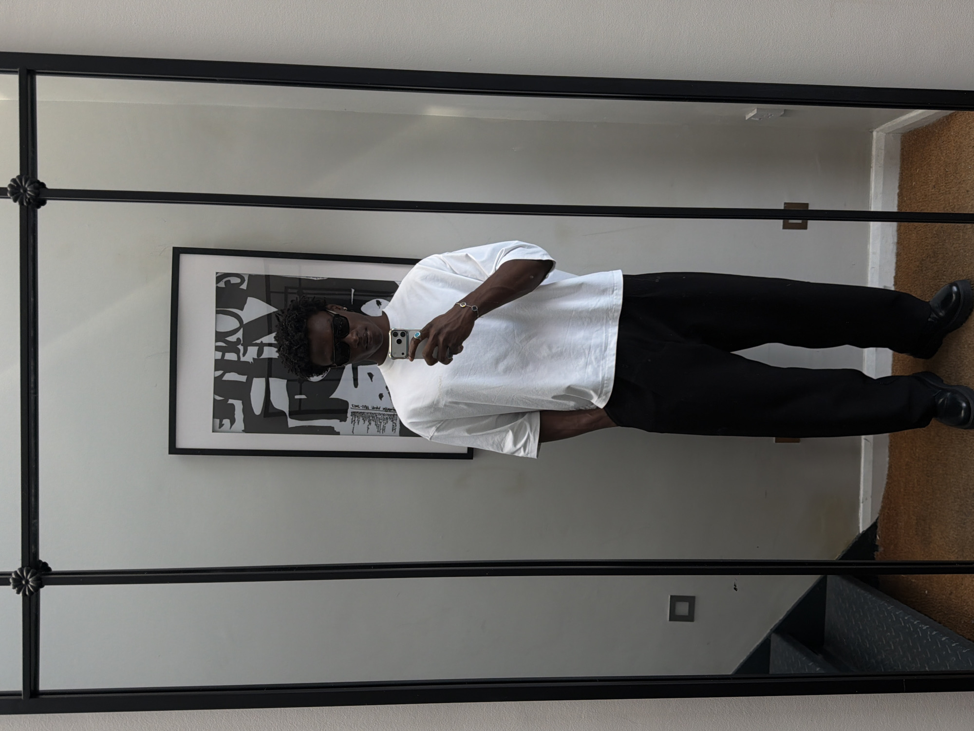 Mirror selfie in a London room, casual daytime shot.