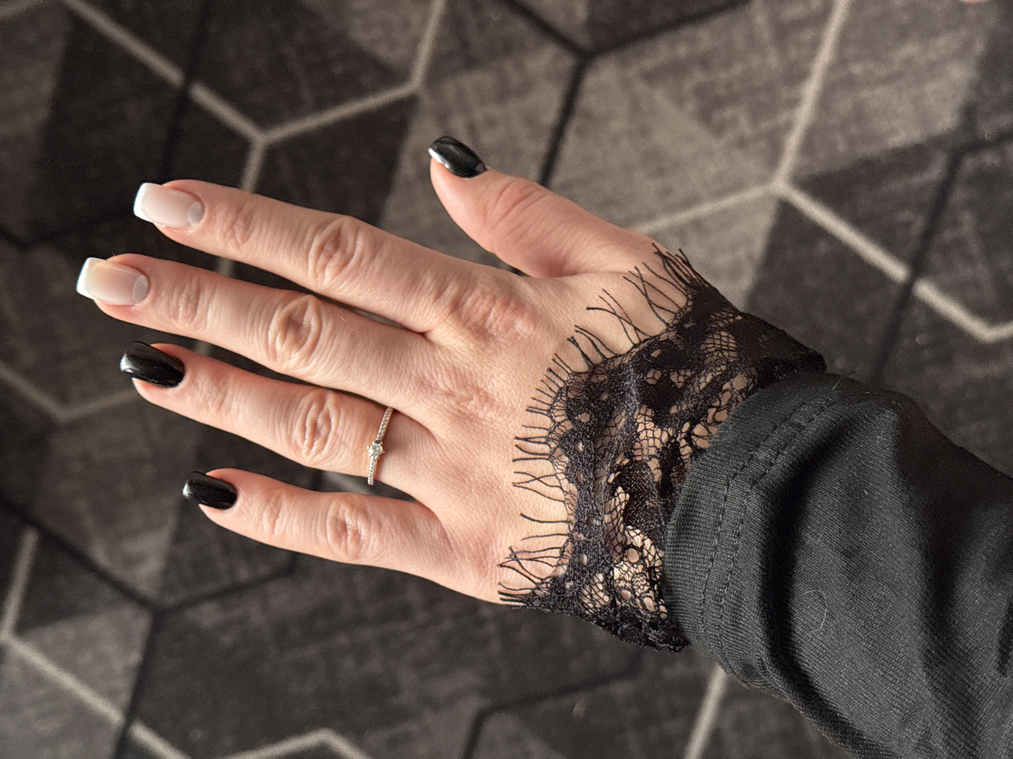 Woman shows manicured nails and diamond ring in Donetsk