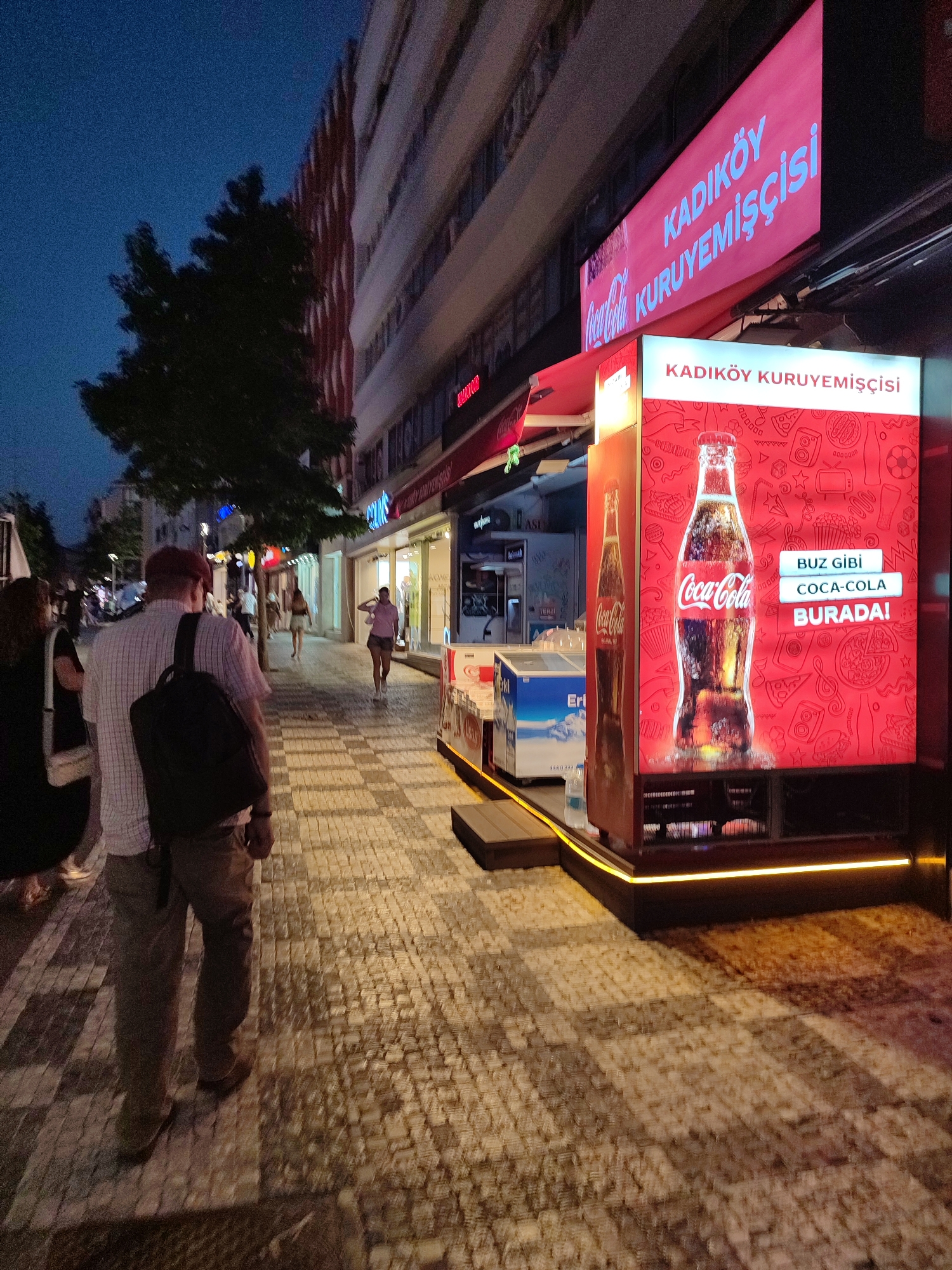 Kadıköy streets at dusk — shops, cats, and evening foot traffic