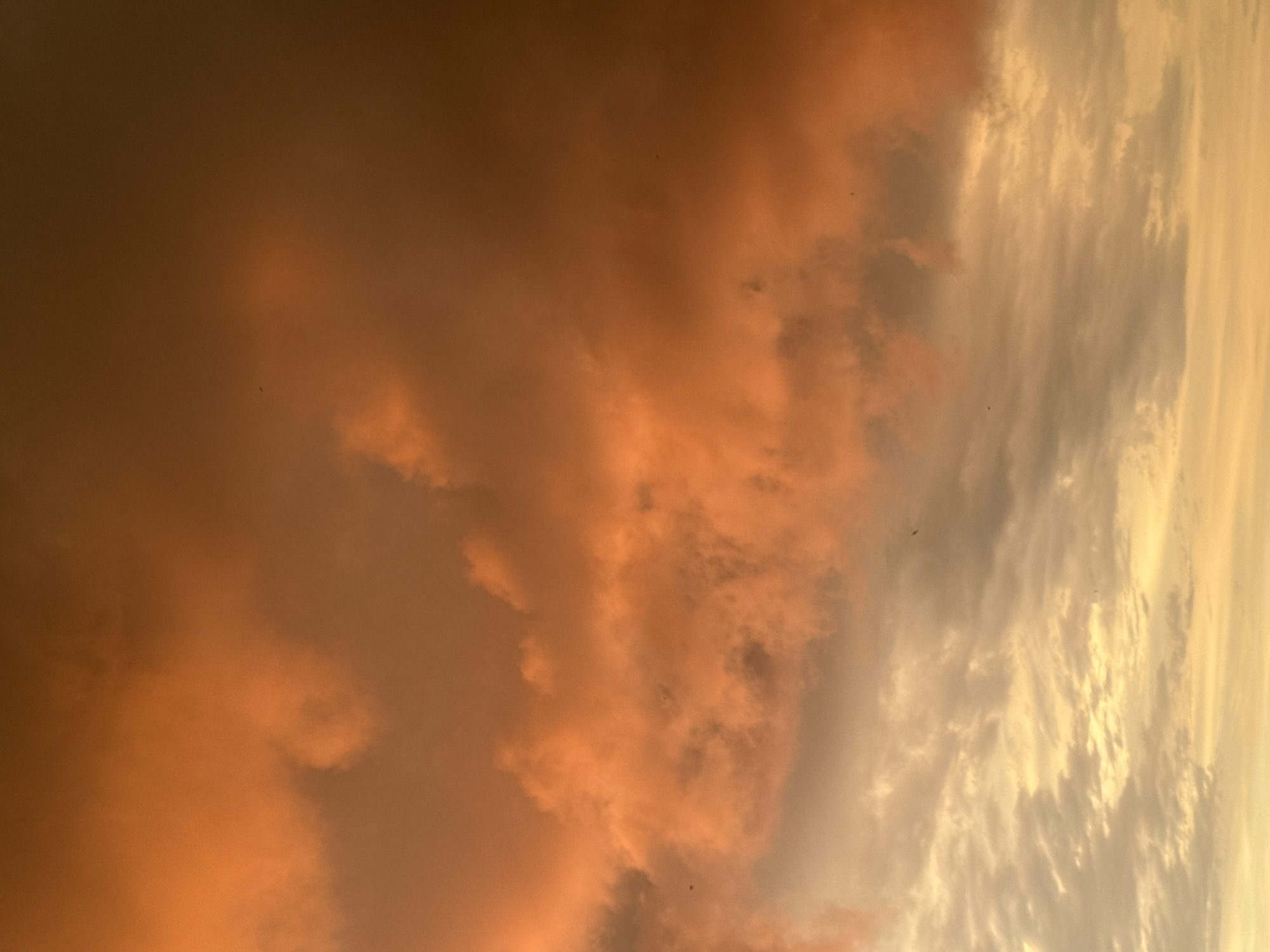 Sunset clouds in warm orange and gray tones