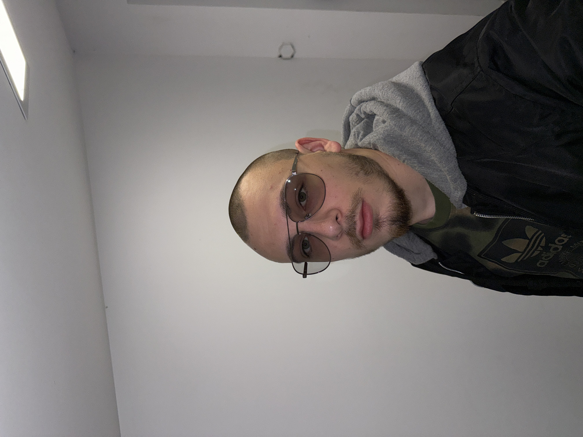 Man in Adidas jacket photographed indoors in Bulgaria