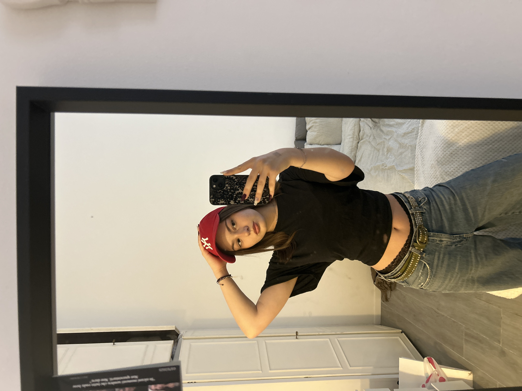Woman takes mirror selfie in Milan wearing casual outfit
