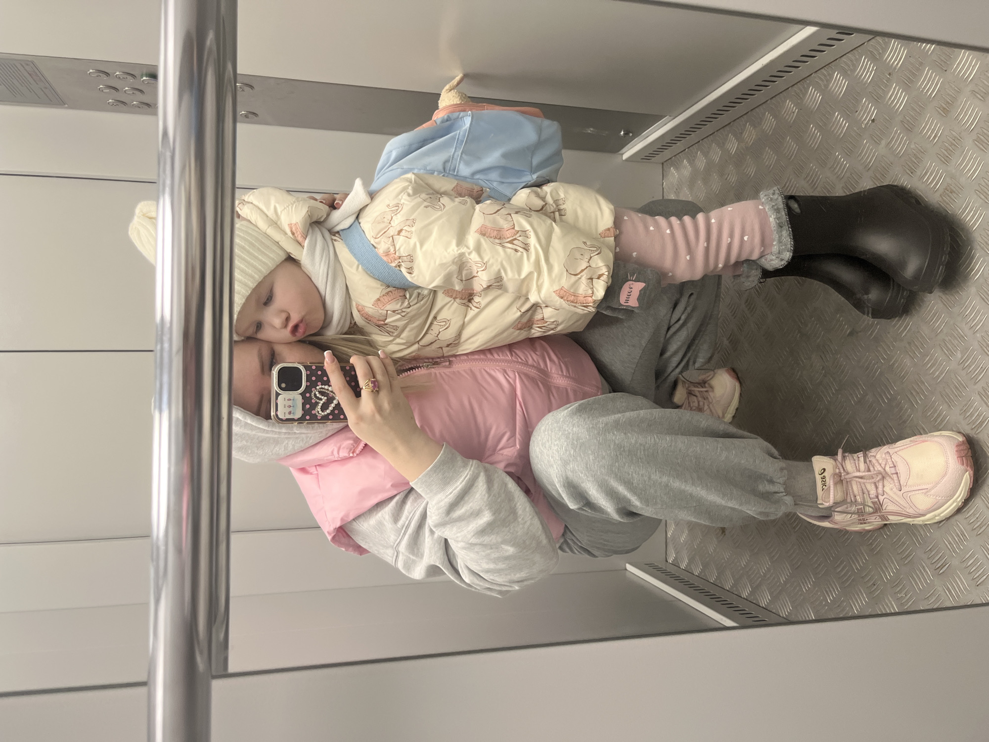 Woman takes multiple mirror selfies with child in Chaikovsky homes