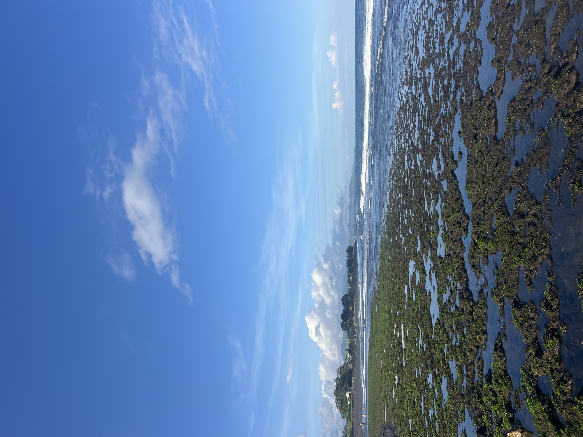 Beach morning documented with tide pools and toys in Blahbatuh