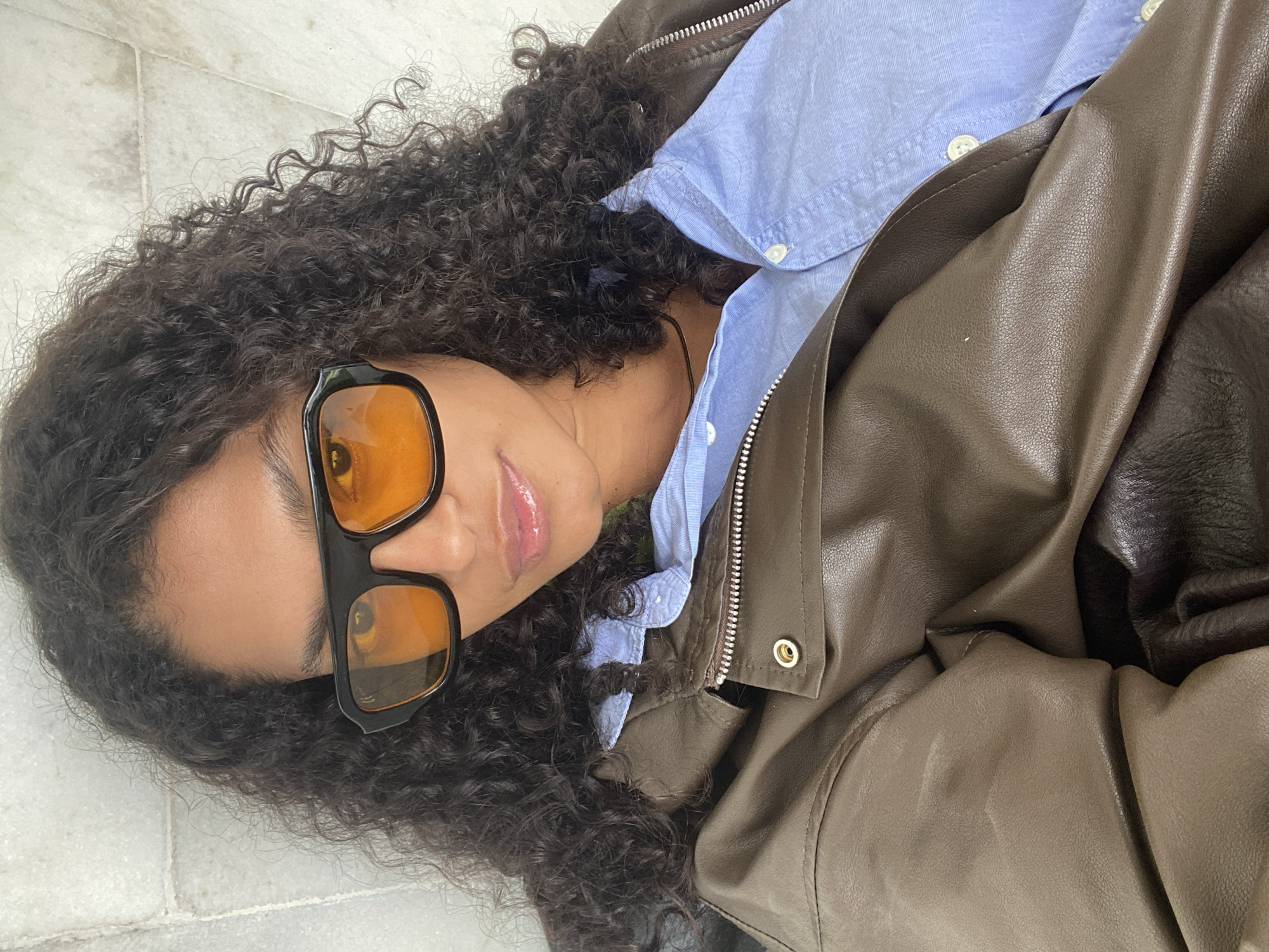 Woman in leather jacket observed lying on floor in São Paulo