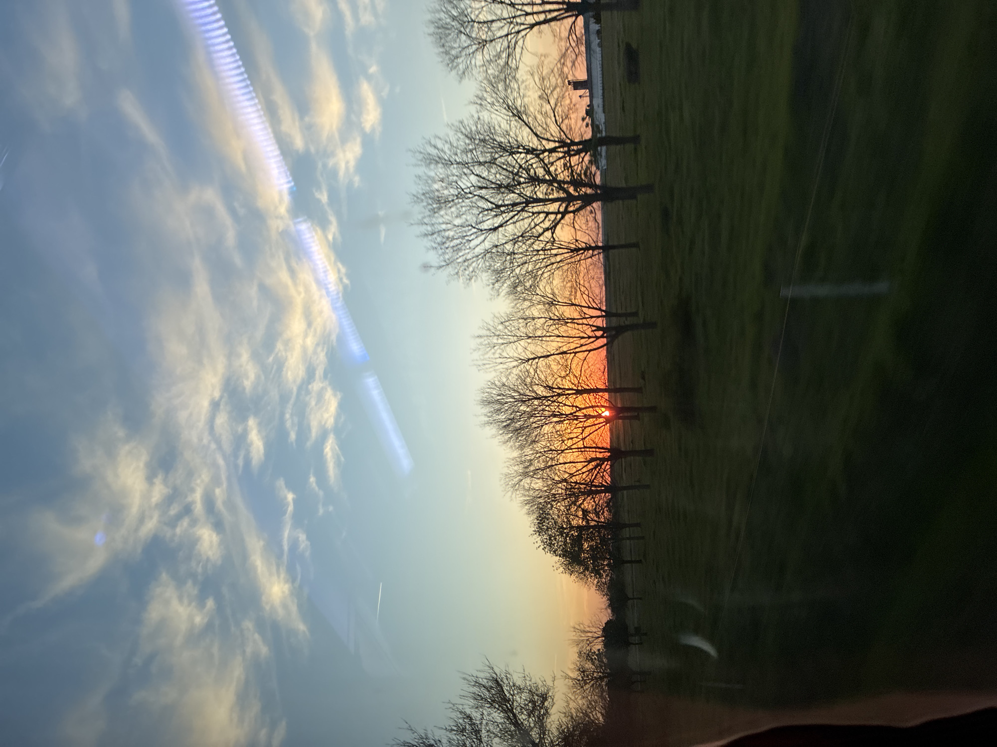 Rural Bulgarian landscape photographed from vehicle during sunset