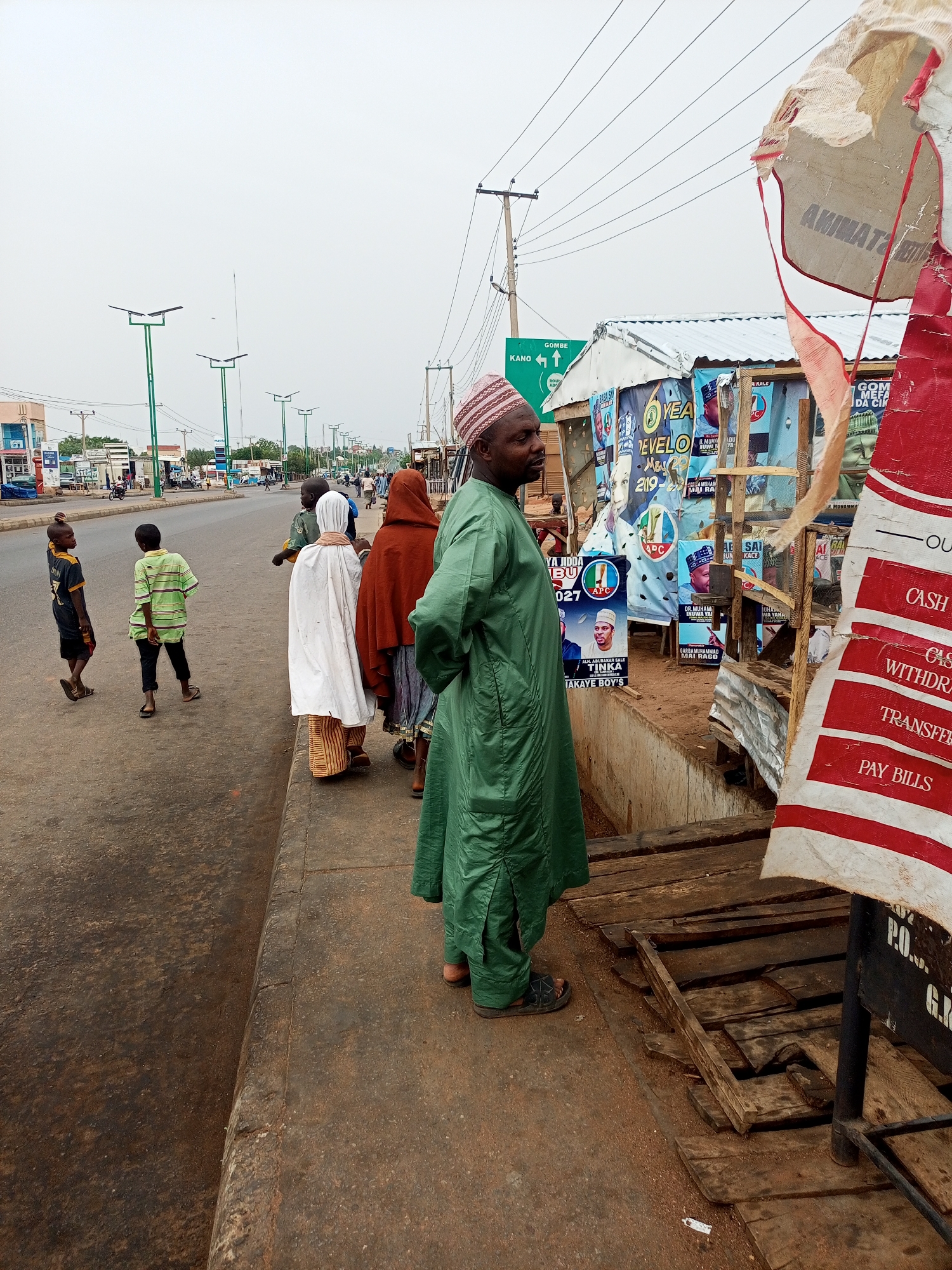 Street scenes show traditional dress, political posters, community life
