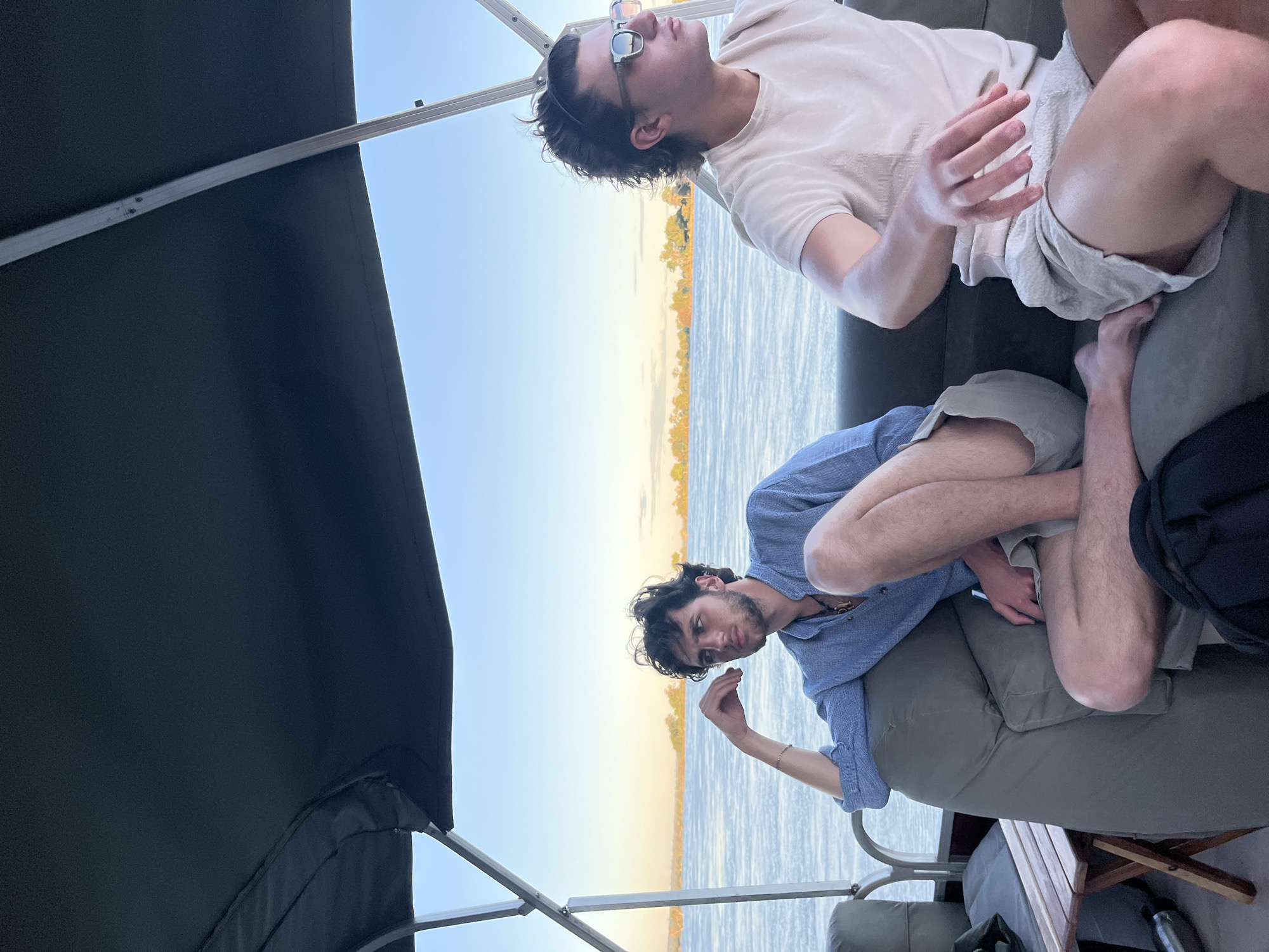 Men enjoy boat leisure time during Zambezi River sunset
