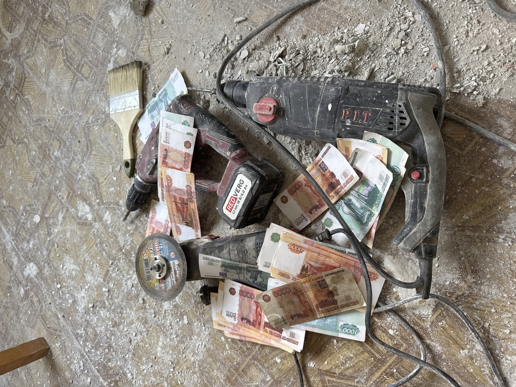 Person poses with cash and construction tools in Russia