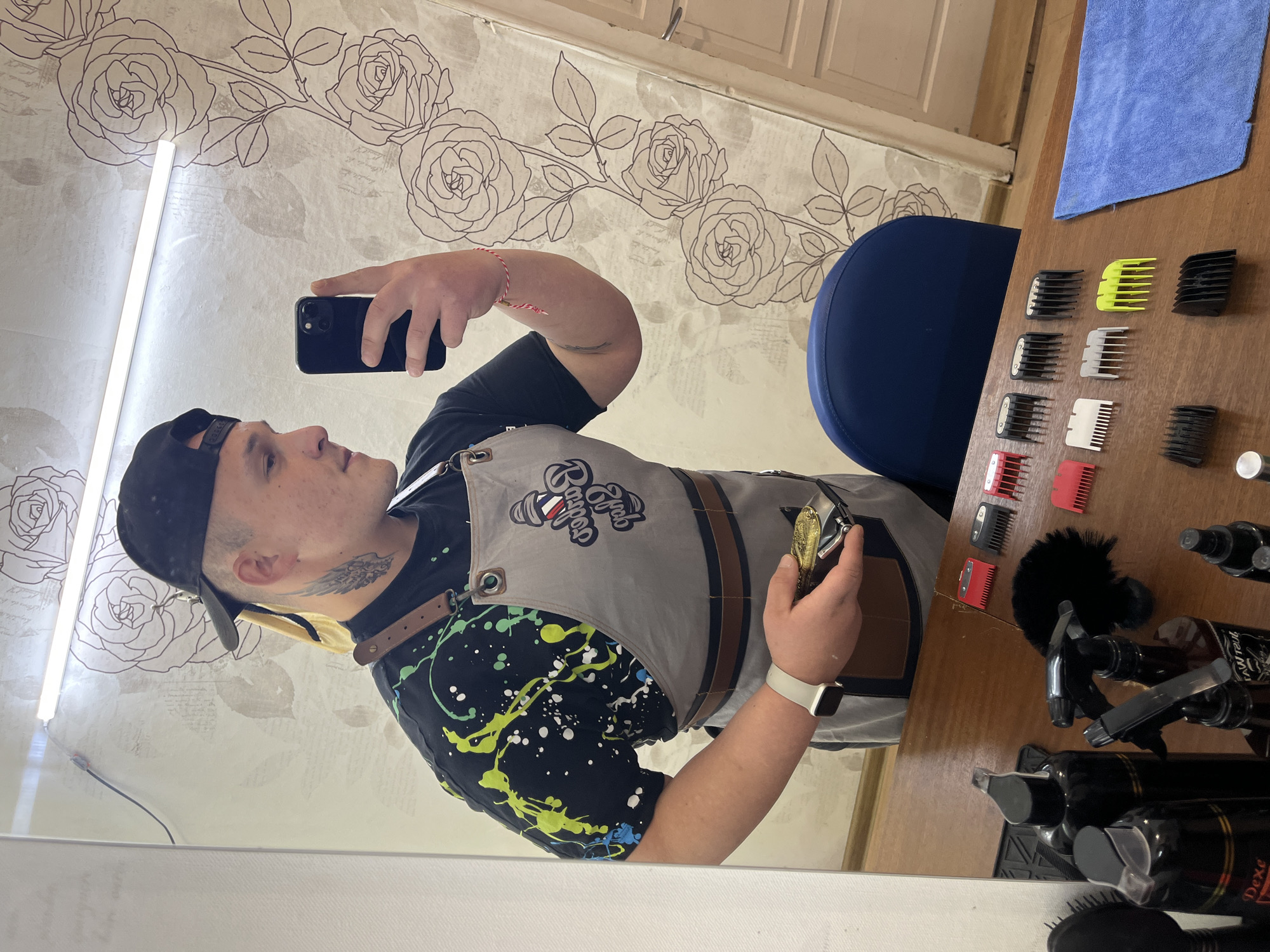 Barber takes mirror selfie at shop in Hirevo, Bulgaria