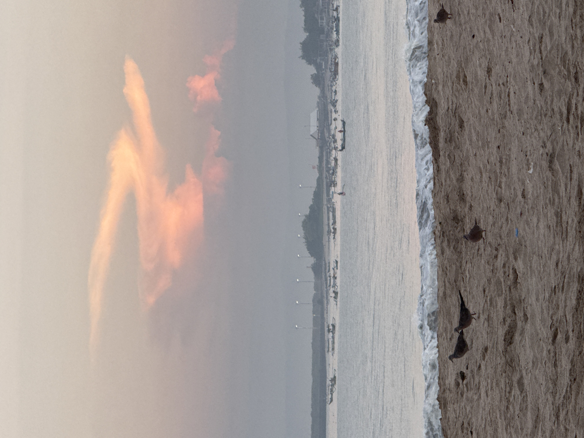Tourist captures evening beach walk in Kuta, Indonesia