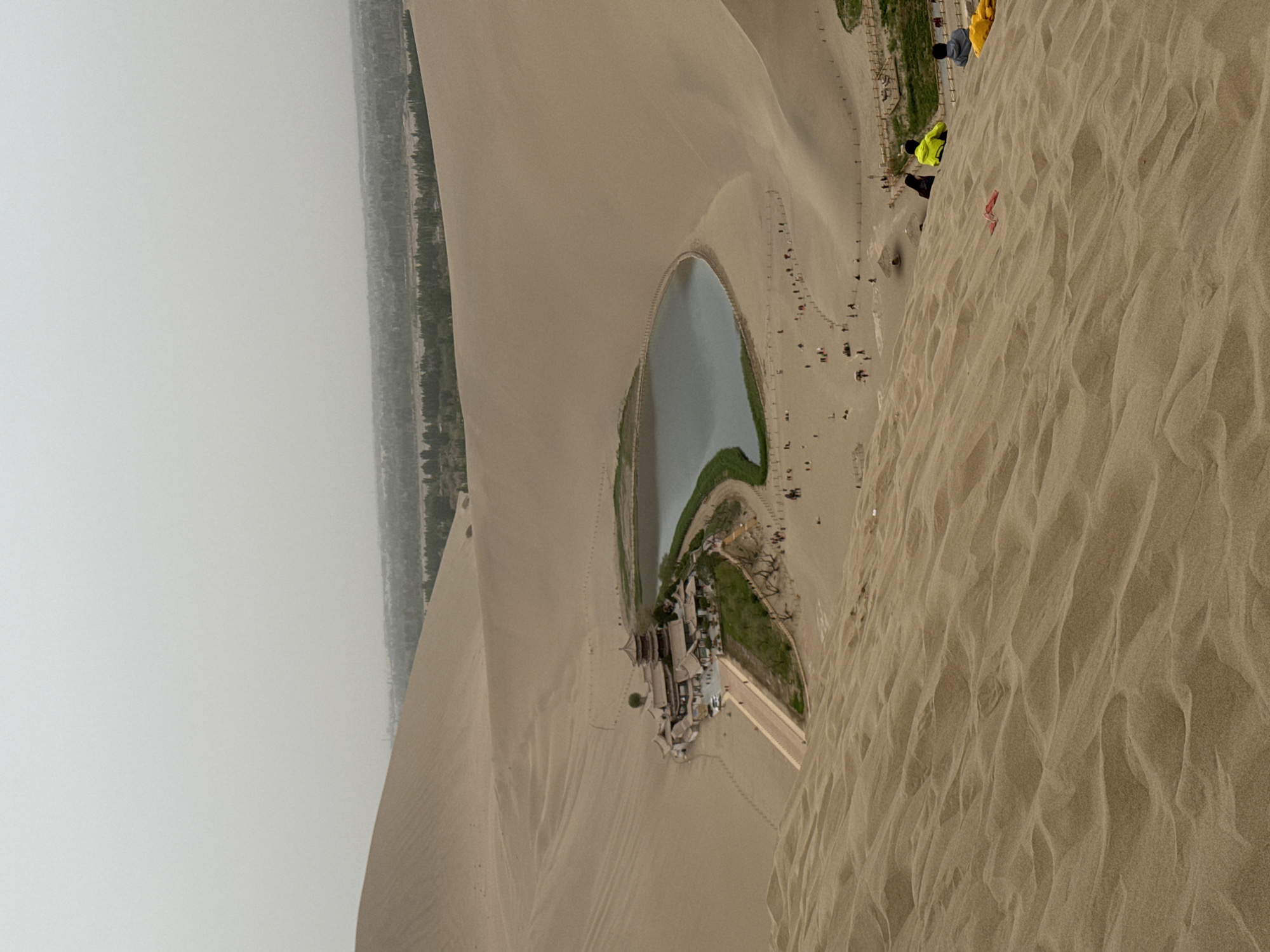 Tourists gather at Crescent Lake desert oasis in Dunhuang