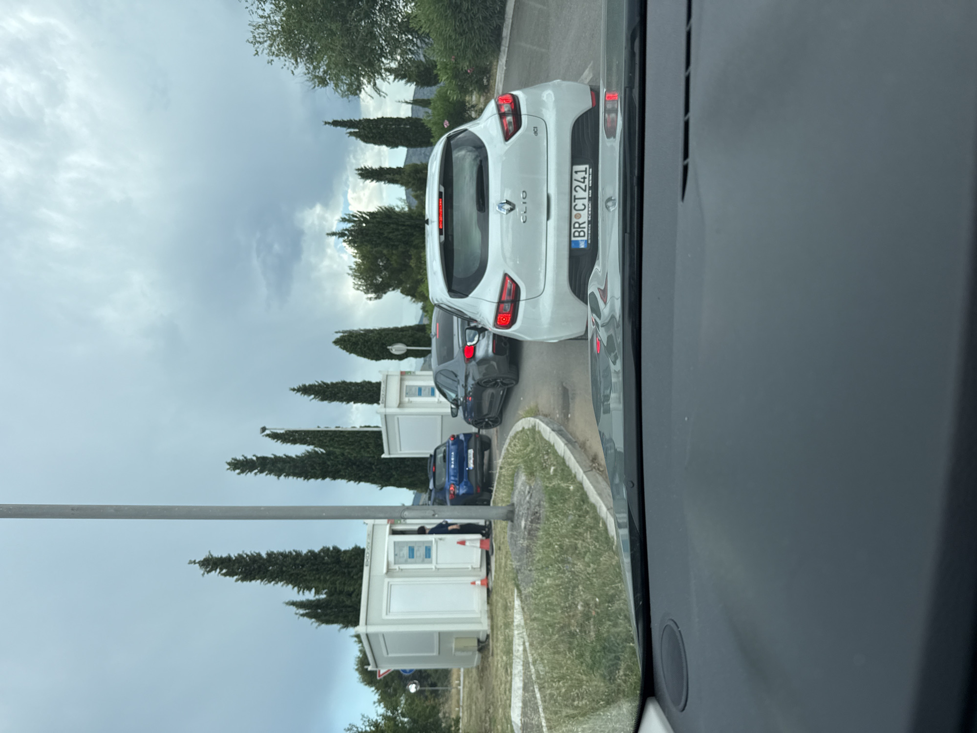 Cars queued at a checkpoint near Podgorica on a cloudy afternoon
