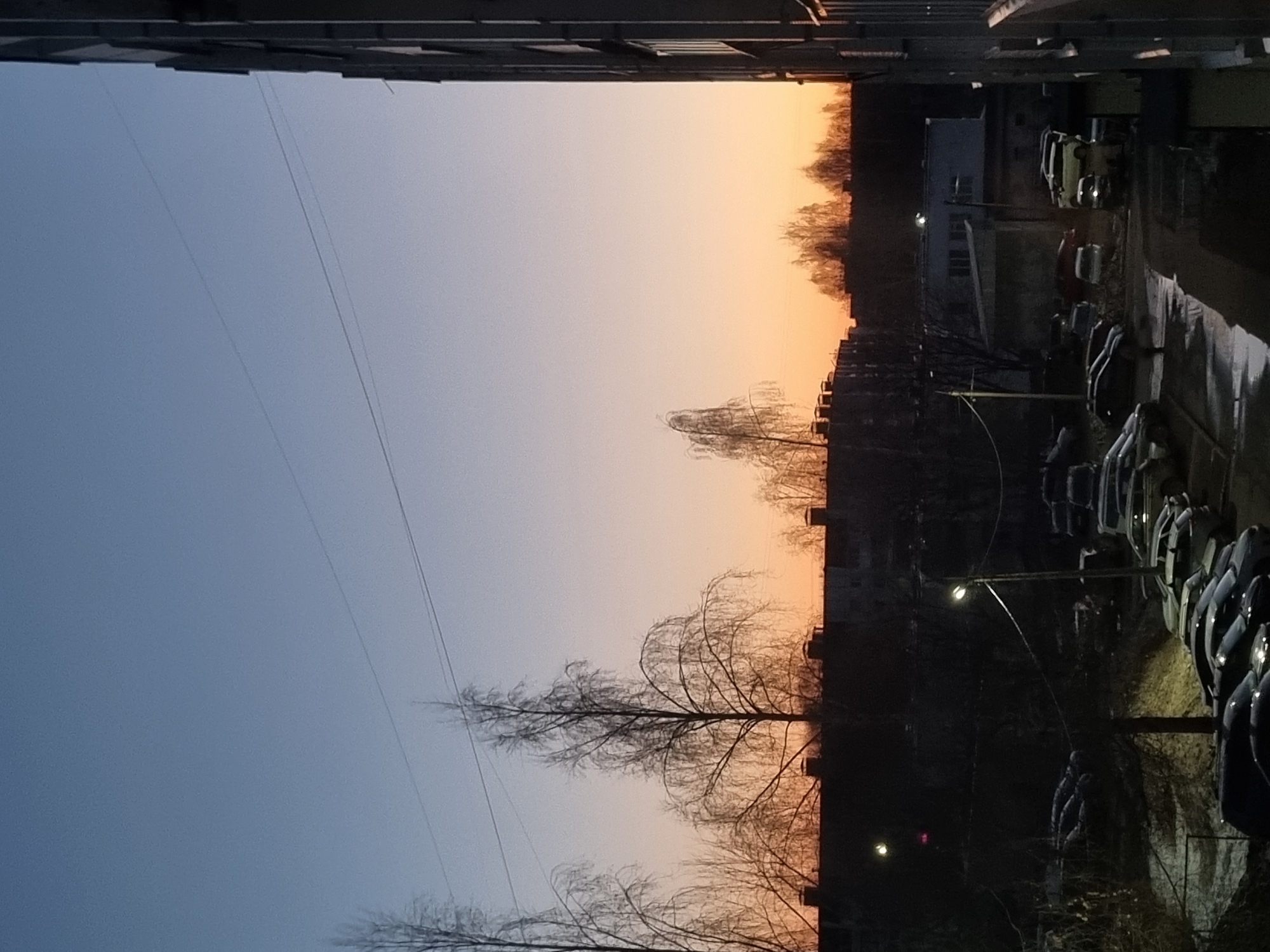 Twilight gradient sky photographed between apartment buildings in Chaikovsky