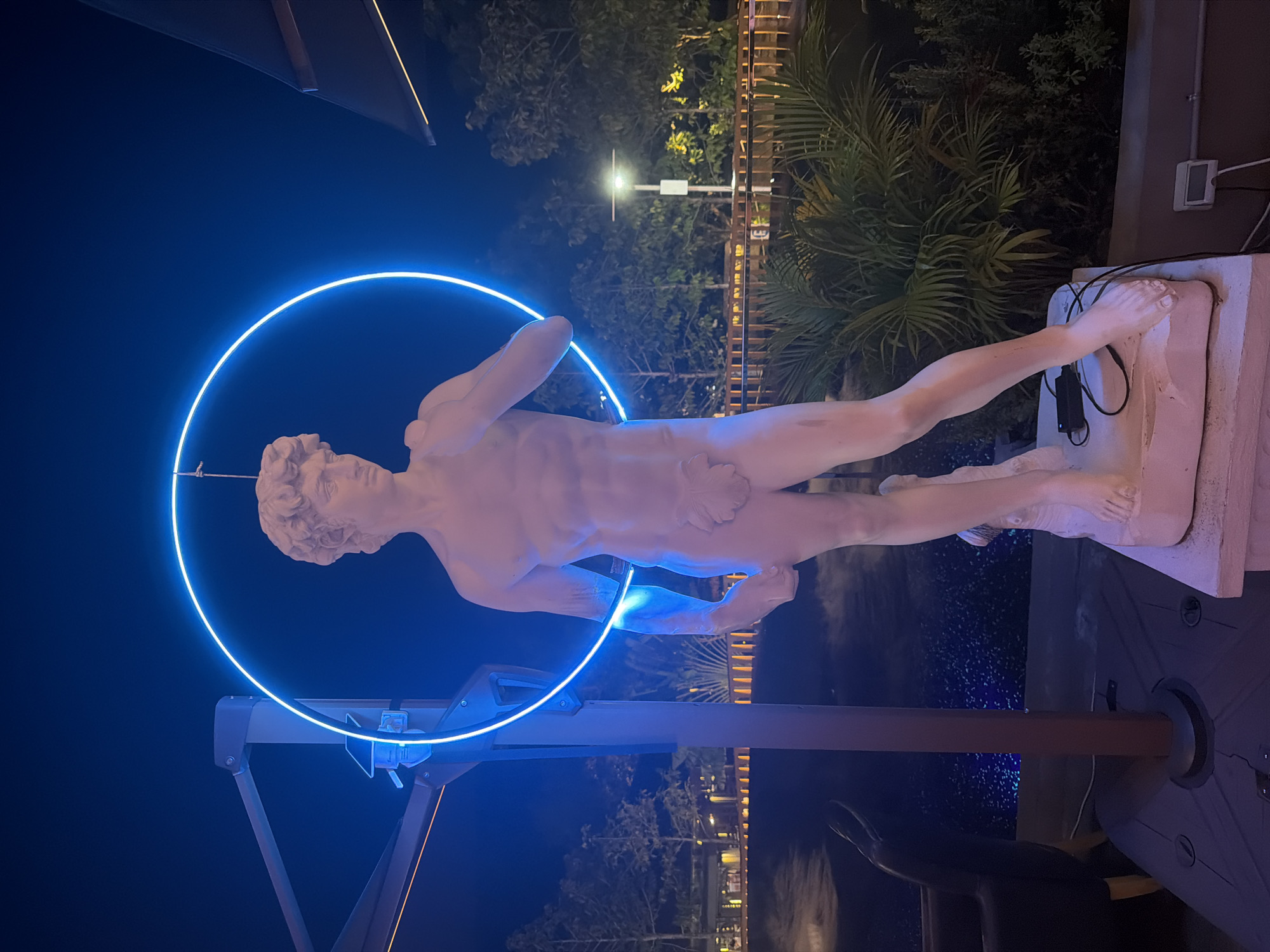 Blue-lit nights in Ko Samui: neon statue and glowing pool