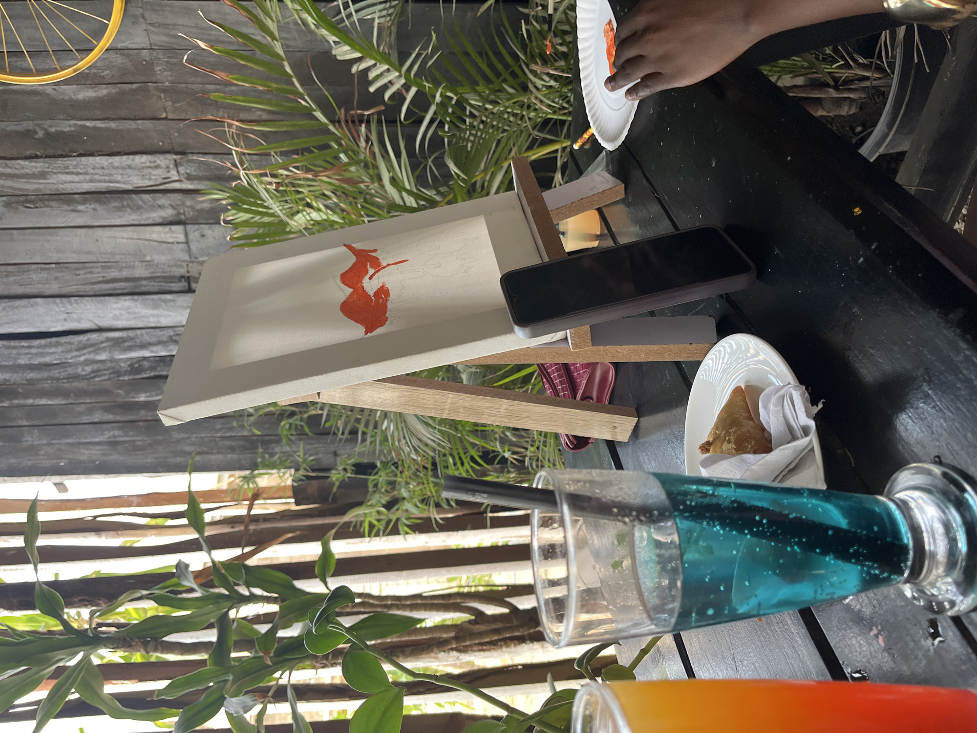Artist paints cocktail scene outdoors in Jos, Nigeria