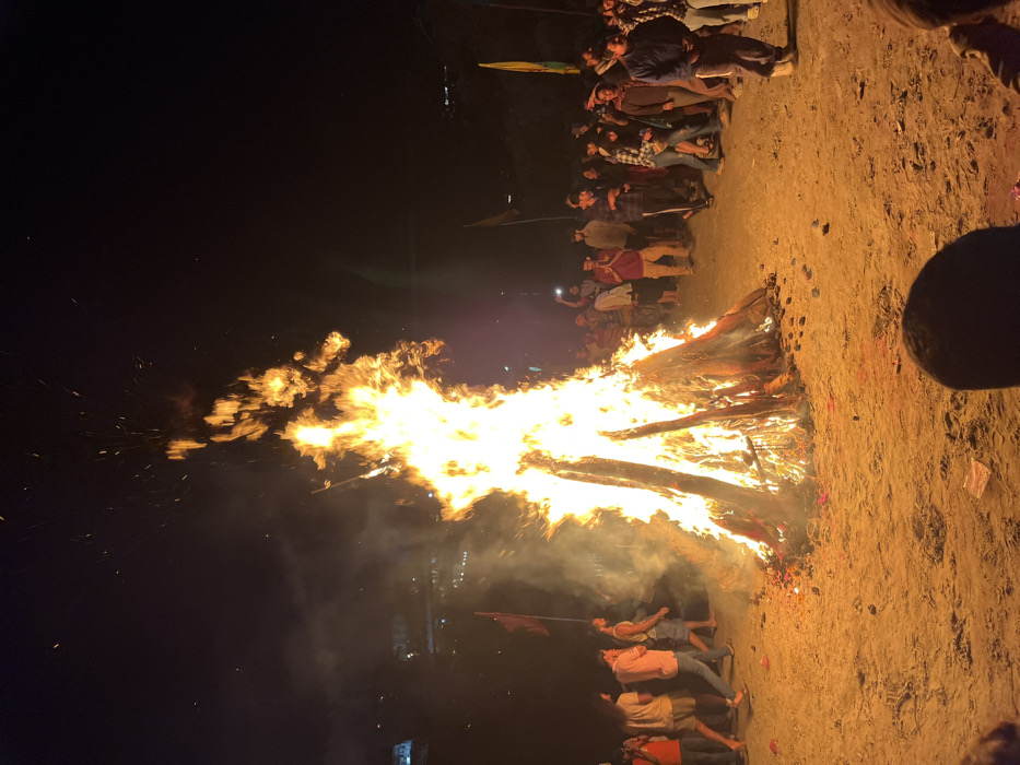Nighttime bonfire gathering draws crowds along Rishikesh riverbank