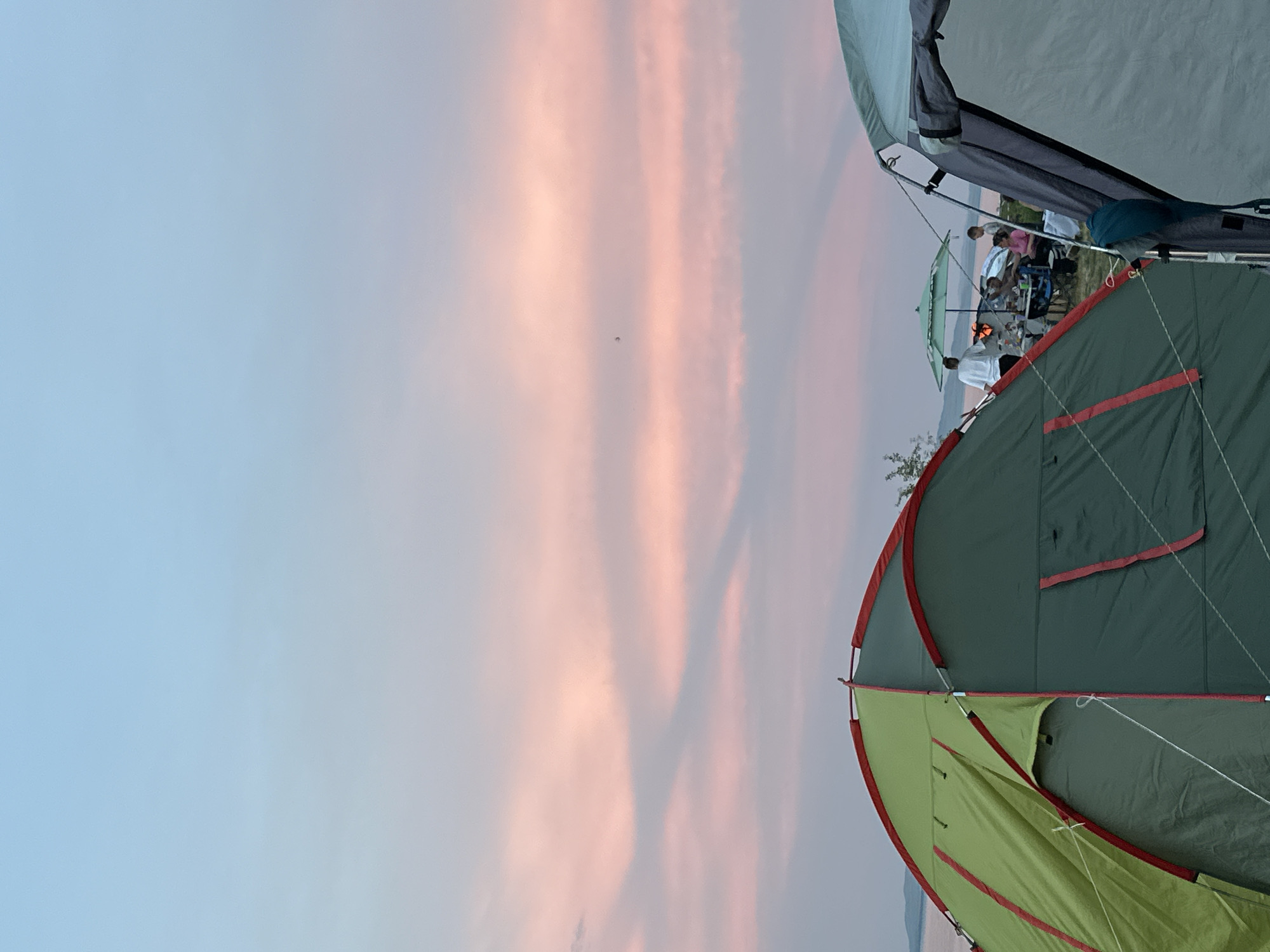 Lakeside campsite in rural Russia, tents up and fire going