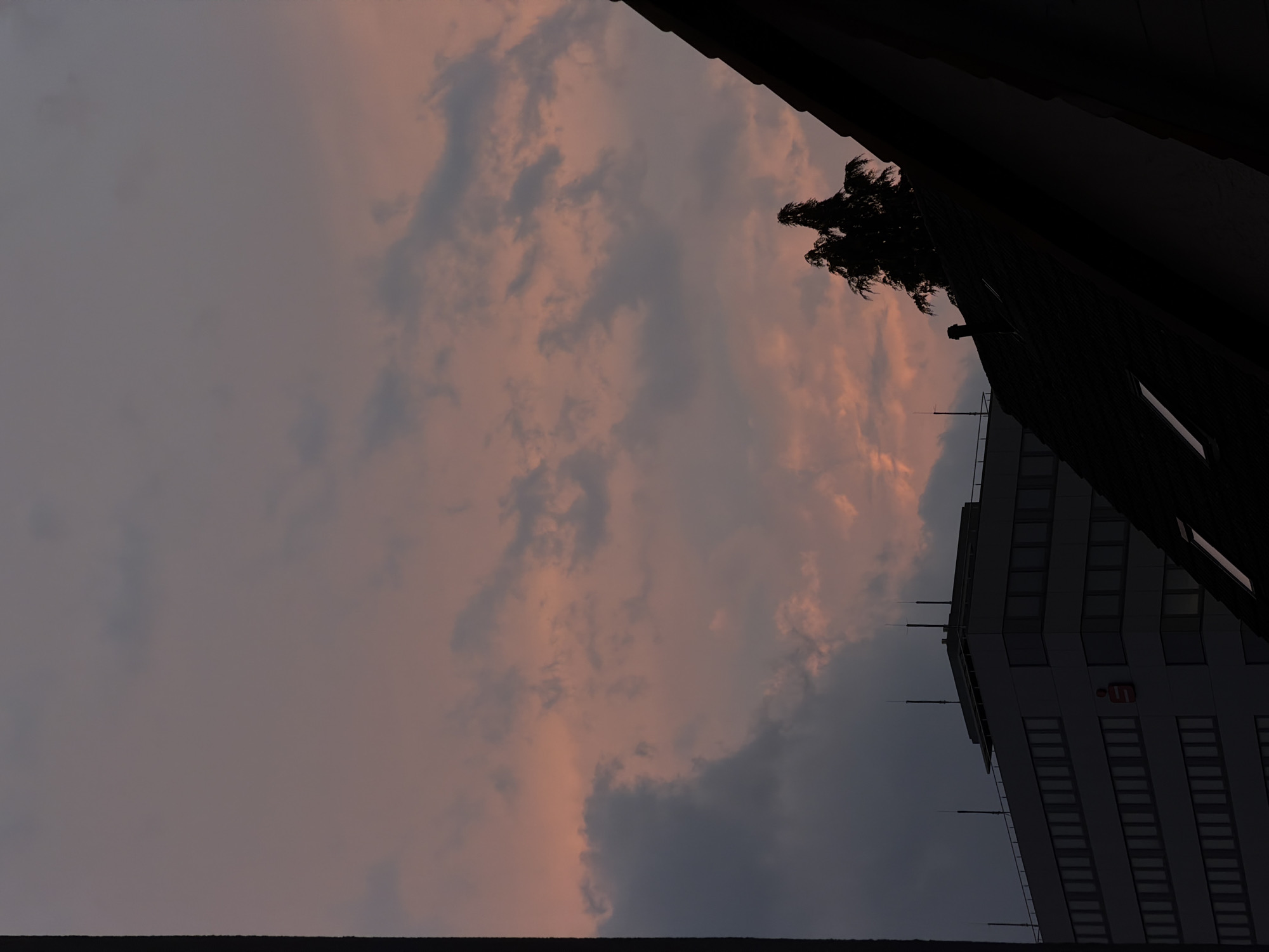 Dusk settles over a half-timbered European town under dramatic skies