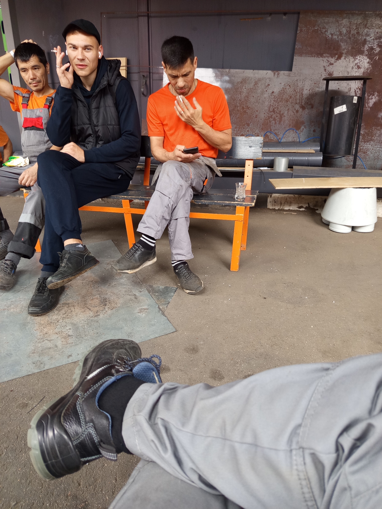 Bench sit-down in Selyatino, cigarette and earbuds in hand