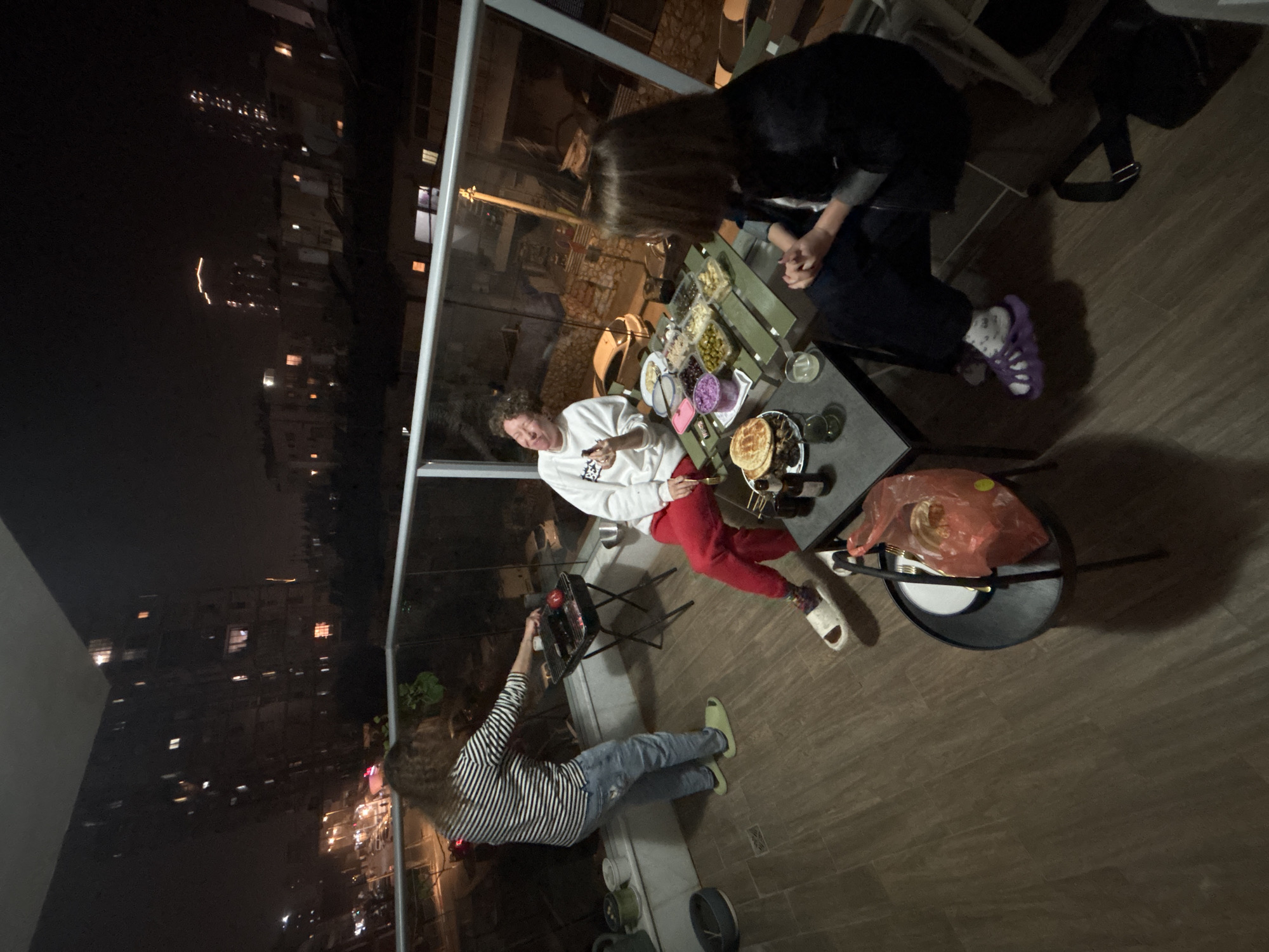 Evening balcony barbecue gathering documented in Bat Yam, Israel
