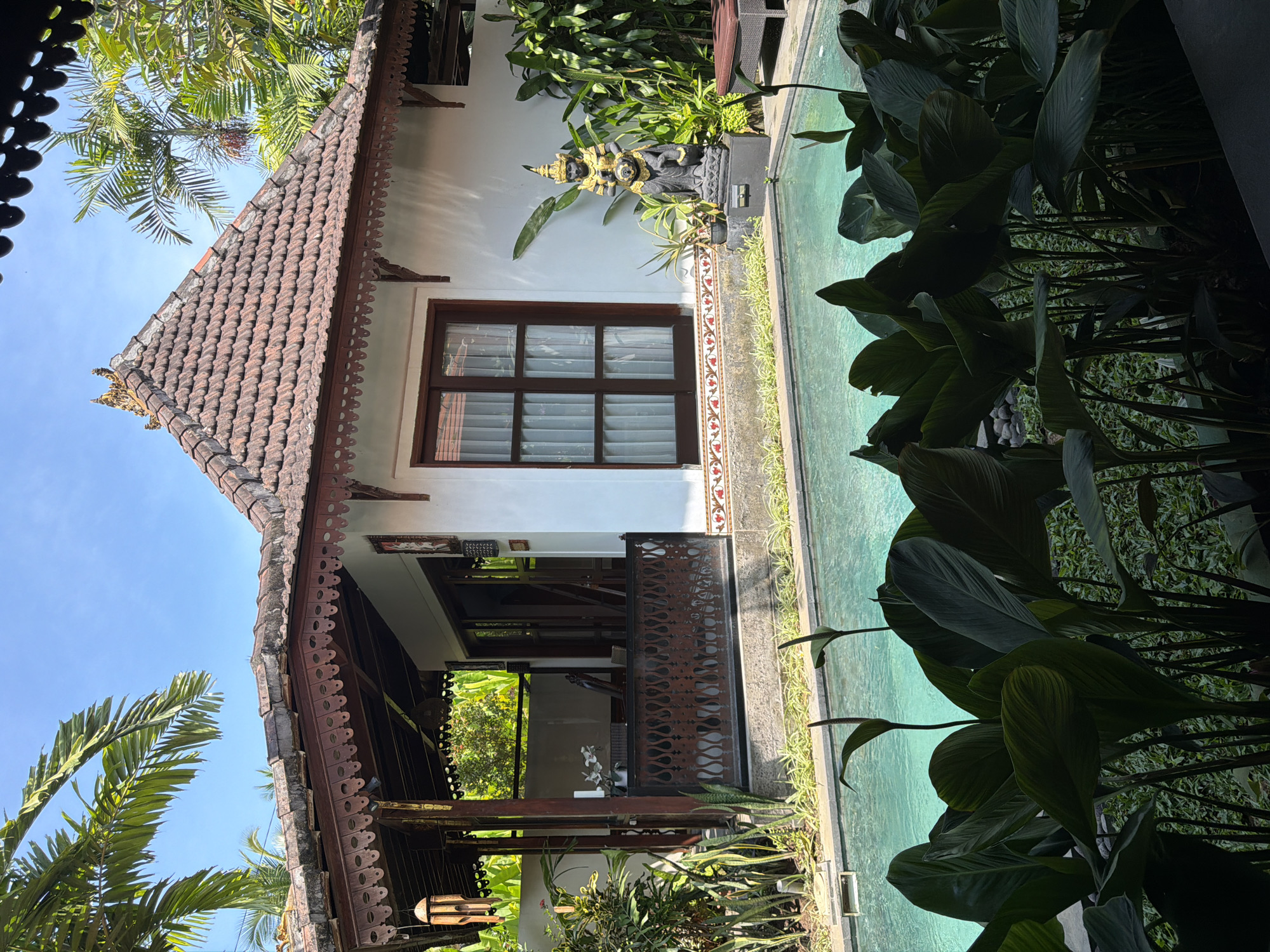 Tourist documents early morning visit to Bali villa resort