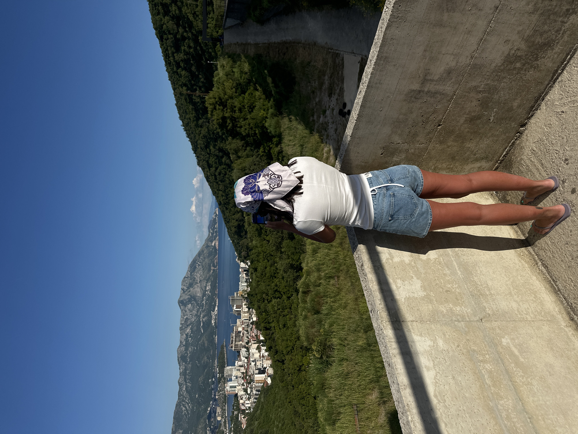 Woman enjoys scenic overlooks of Montenegro coastal cities
