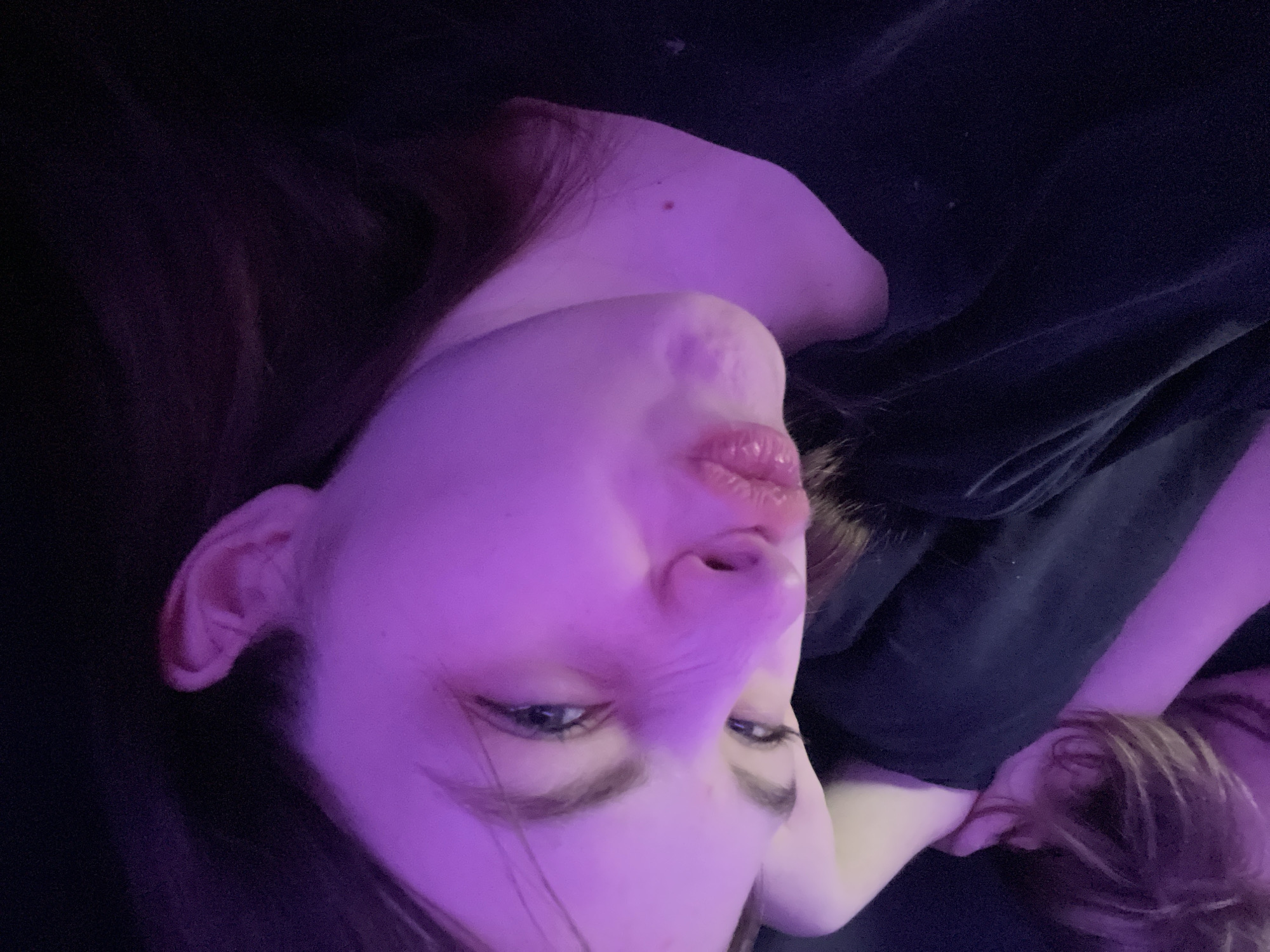 Intimate domestic moments captured in purple-lit Saint Petersburg interior
