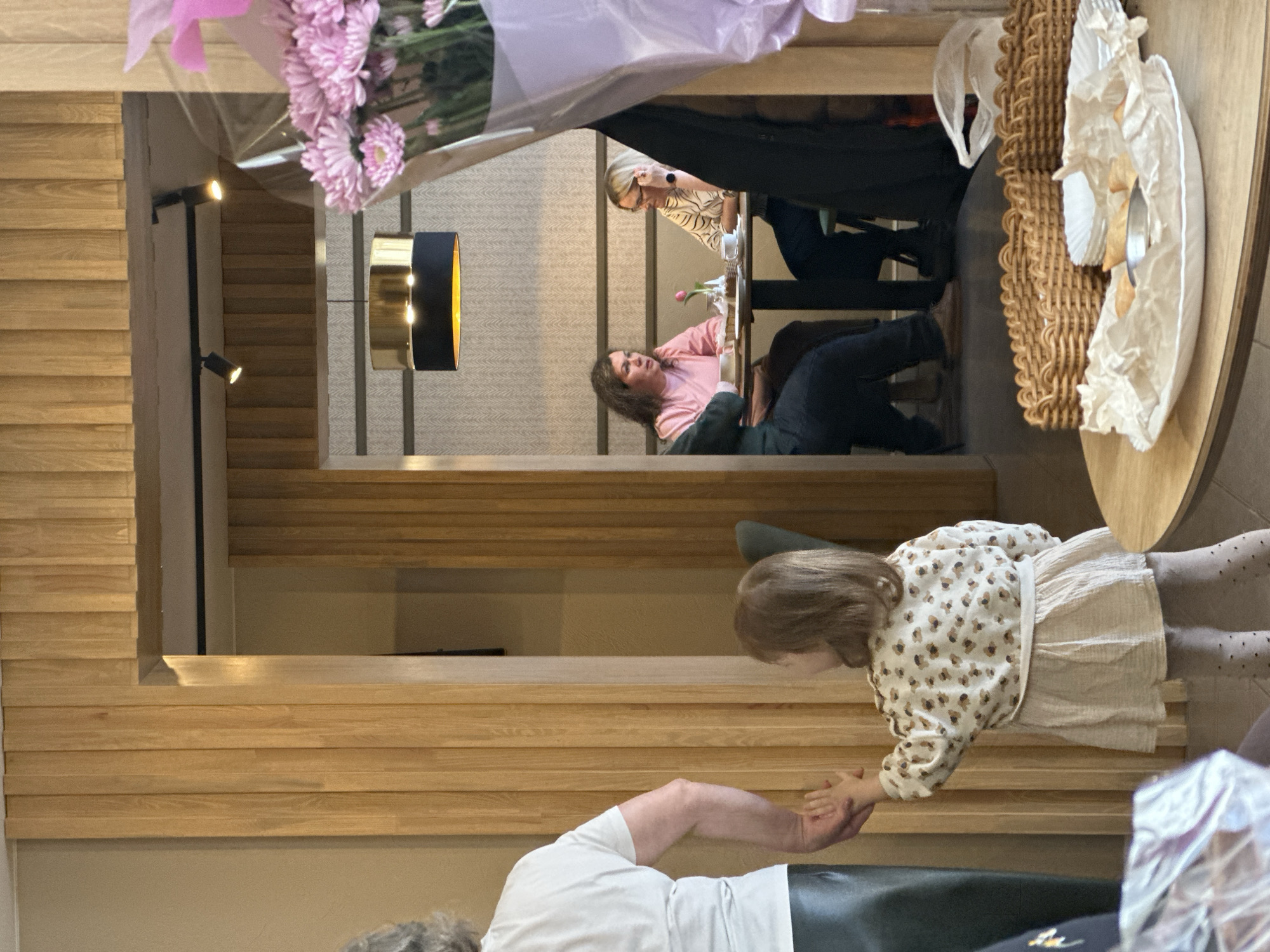 Two women dine at Dobryanka restaurant with pink flowers